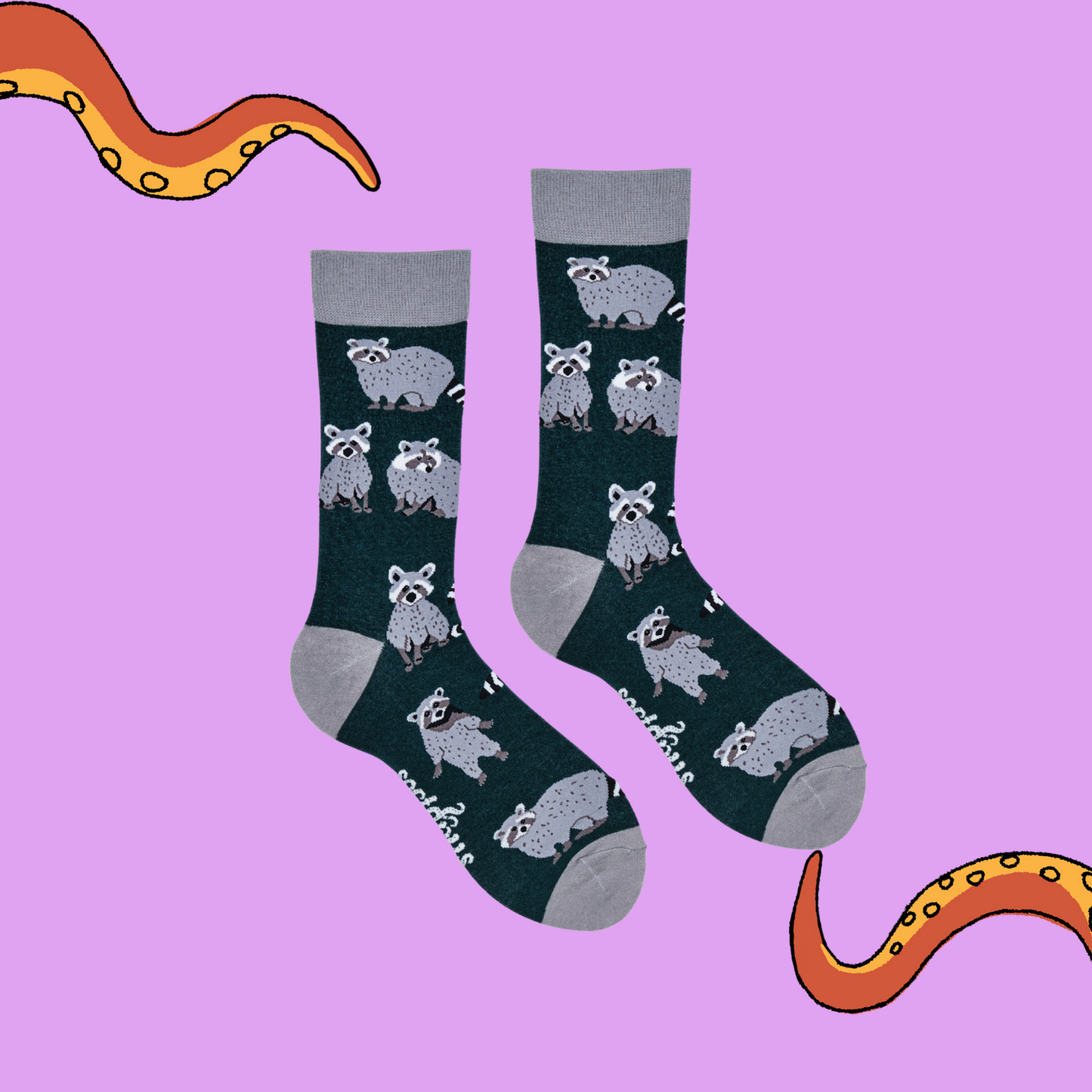 A pair of socks depicting raccoons. Green legs, grey cuff, heel and toe.