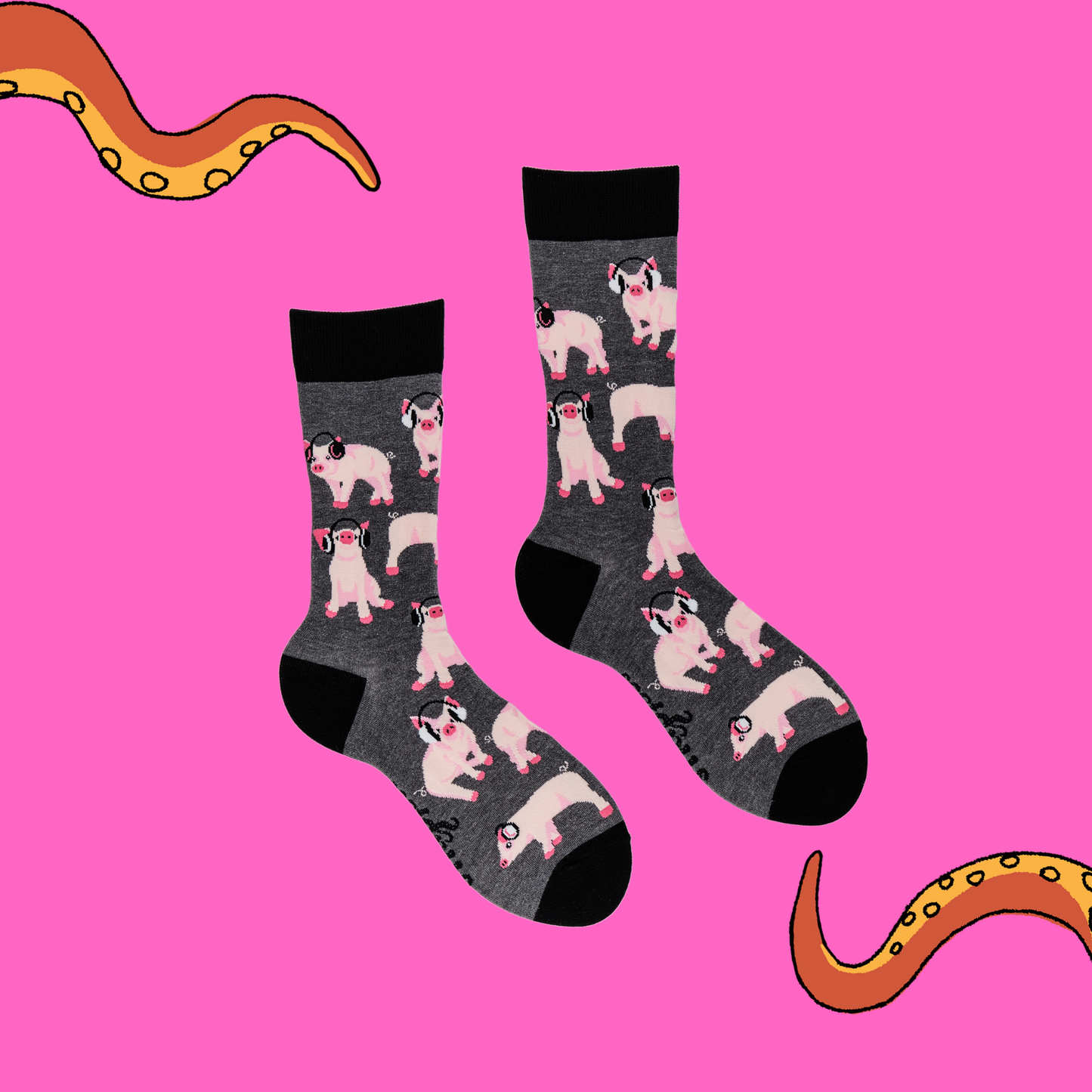 A pair of socks depicting Pigs being wearing headphones. Grey legs, black cuff, heel and toe. Pink background with Soctopus tentacles.