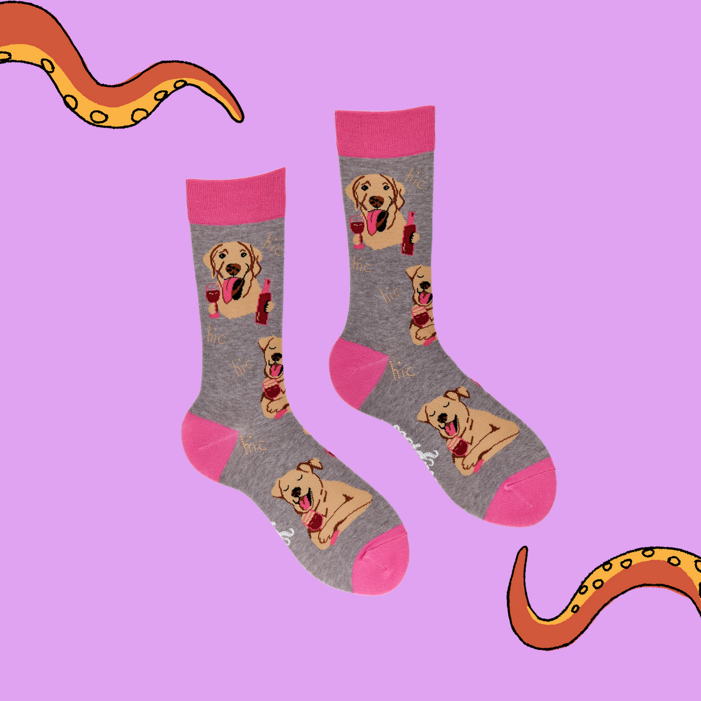 A pair of socks depicting labs drinking wine. Grey legs, light pink cuff, heel and toe.