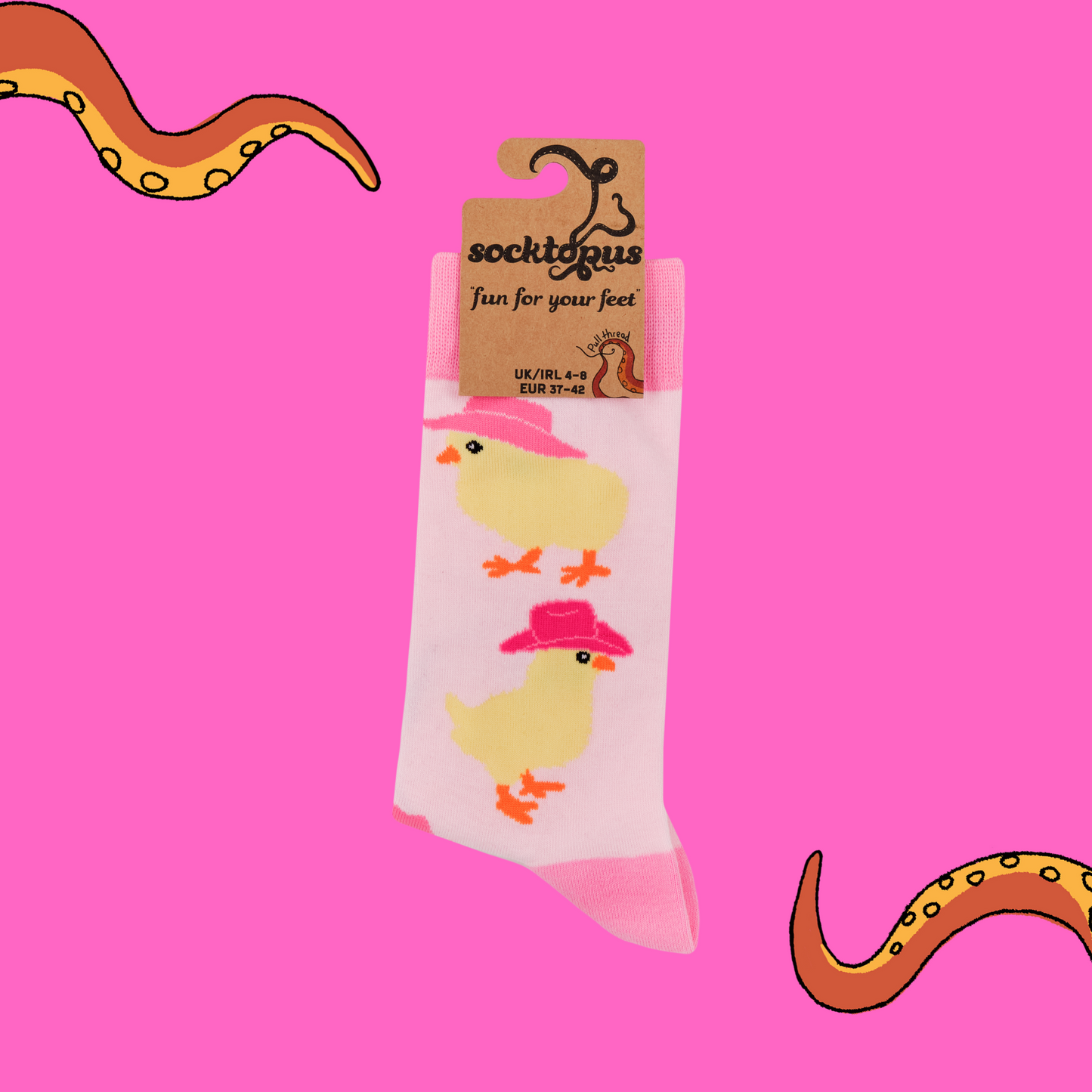 A pair of socks with a chick in cowboy hats motif. Light pink legs, dark pink heel, toe and cuff.