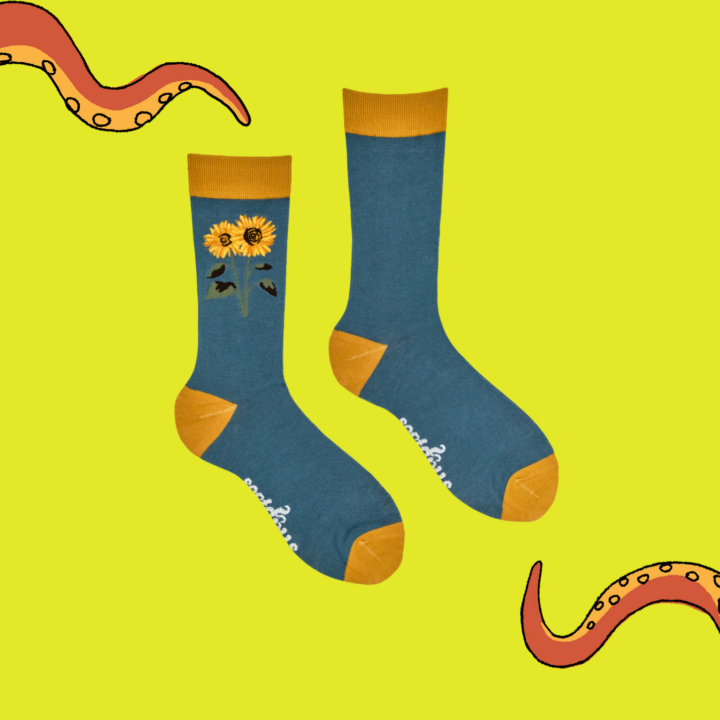 Blue socks with sunflower design on a yellow background