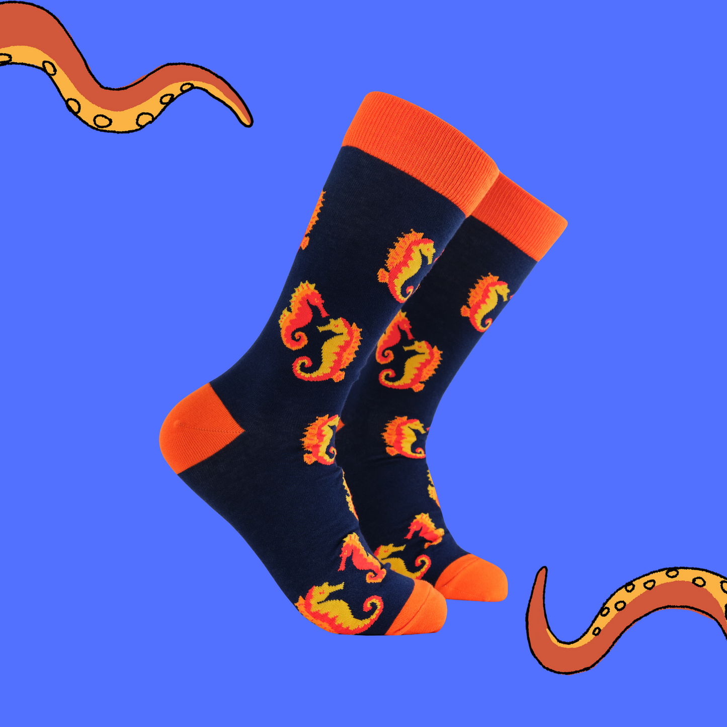 A pair of socks with a seahorse motif. Dark blue legs, red heel, toe and cuff.