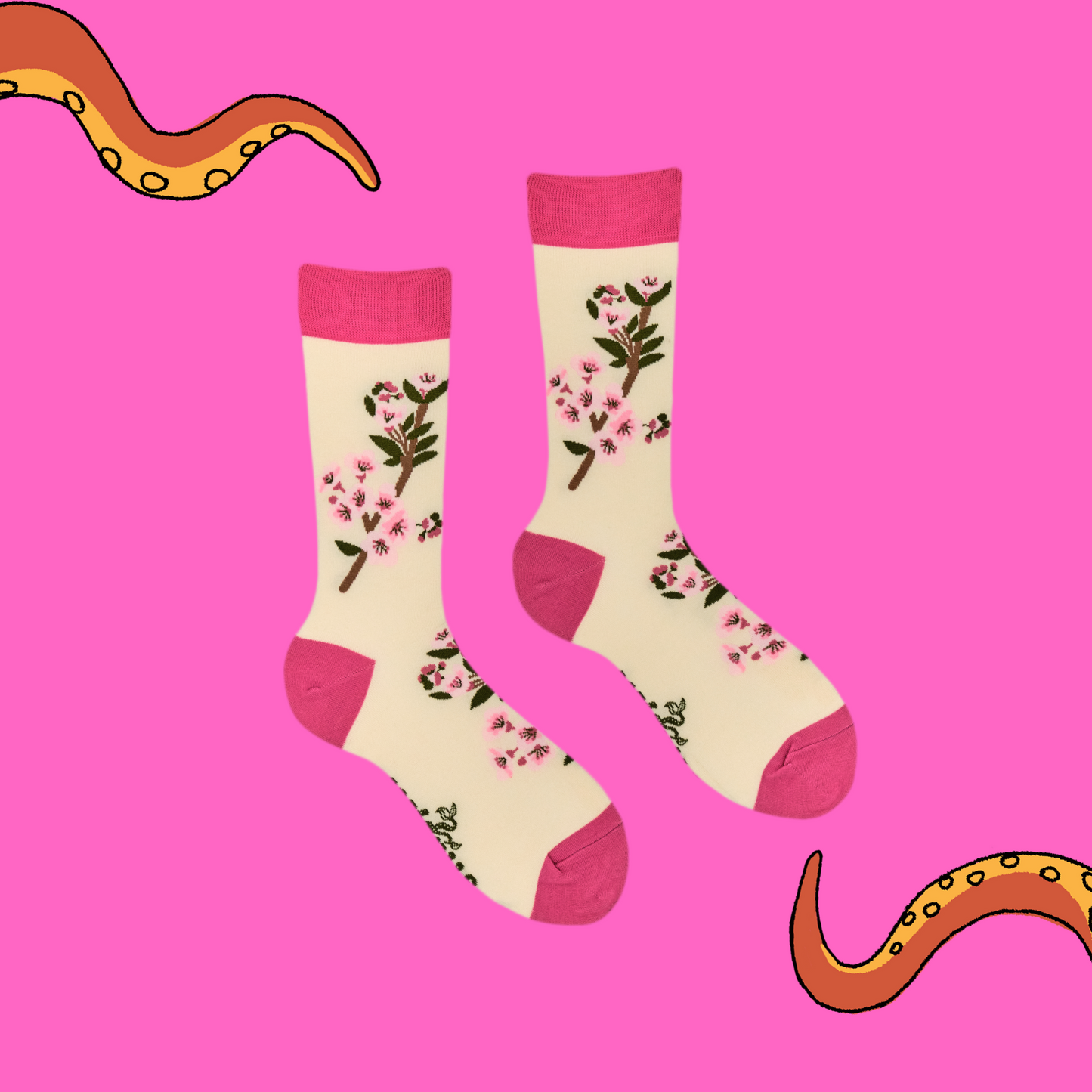 A pair of socks featuring cherry blossom. Beige legs, bright pink heel, toe and cuff.