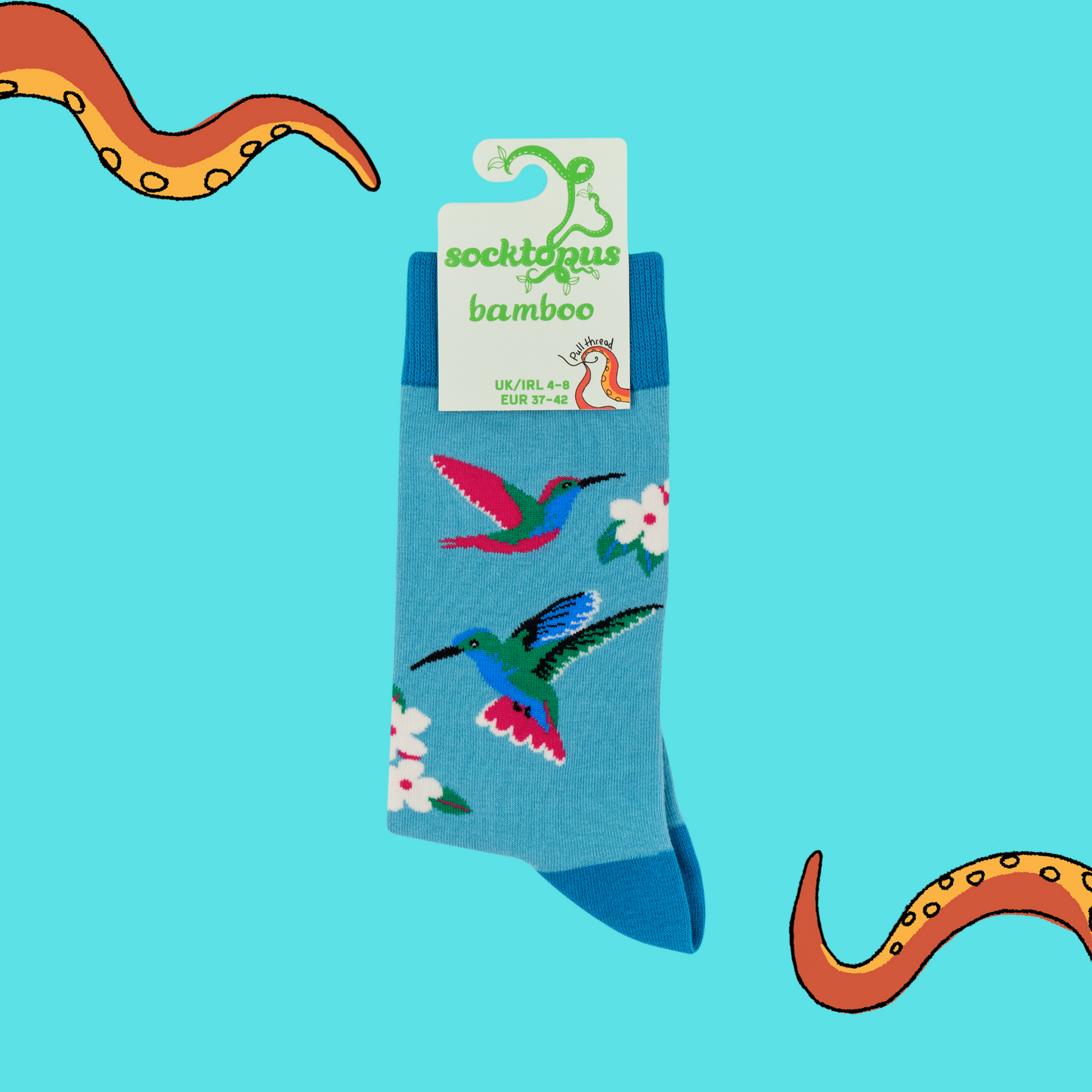 A pair of socks with a hummingbird motif. Blue legs, dark blue heel, toe and cuff.