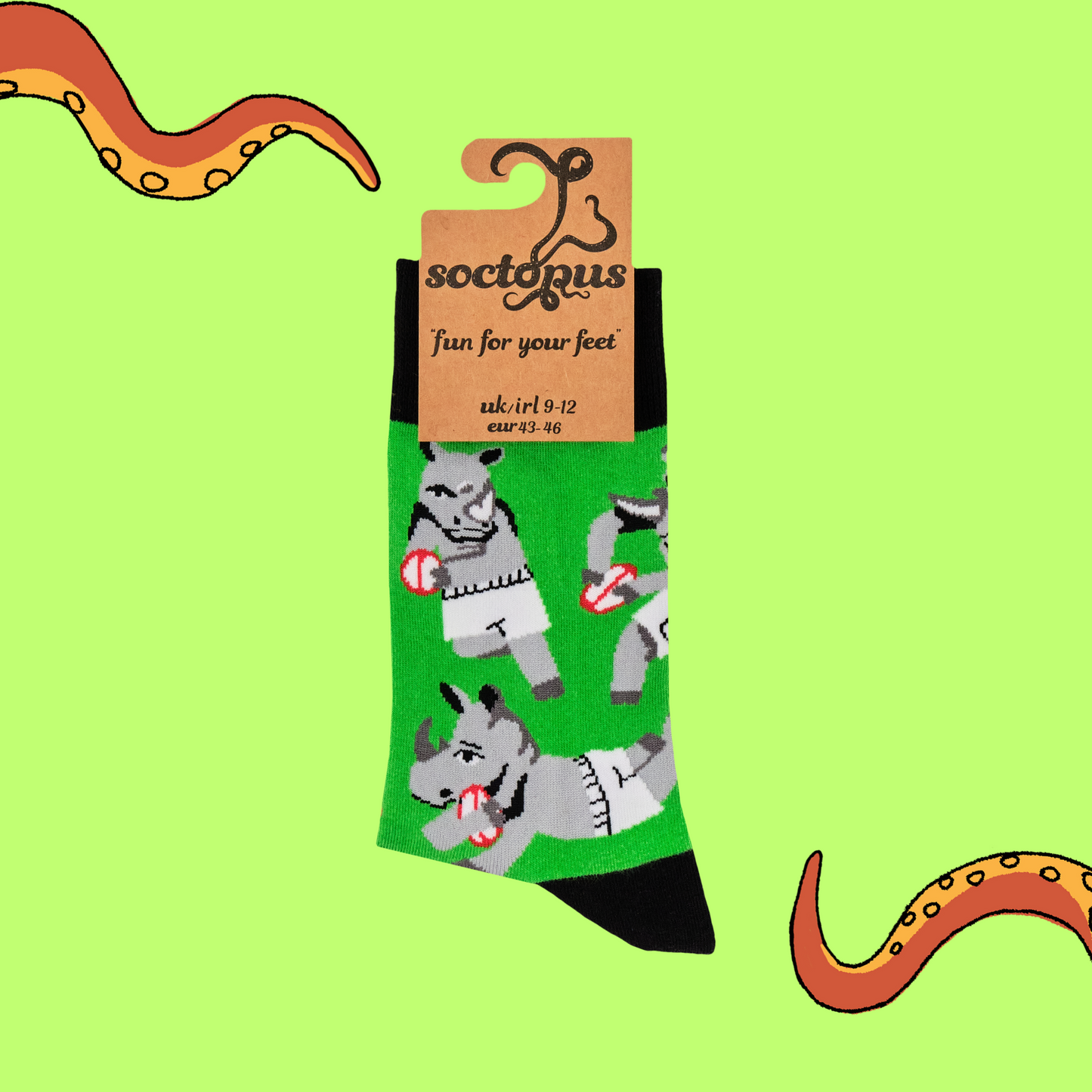 A pair of socks featuring rhinos playing rugby. Green legs, black heel, toe and cuff.
