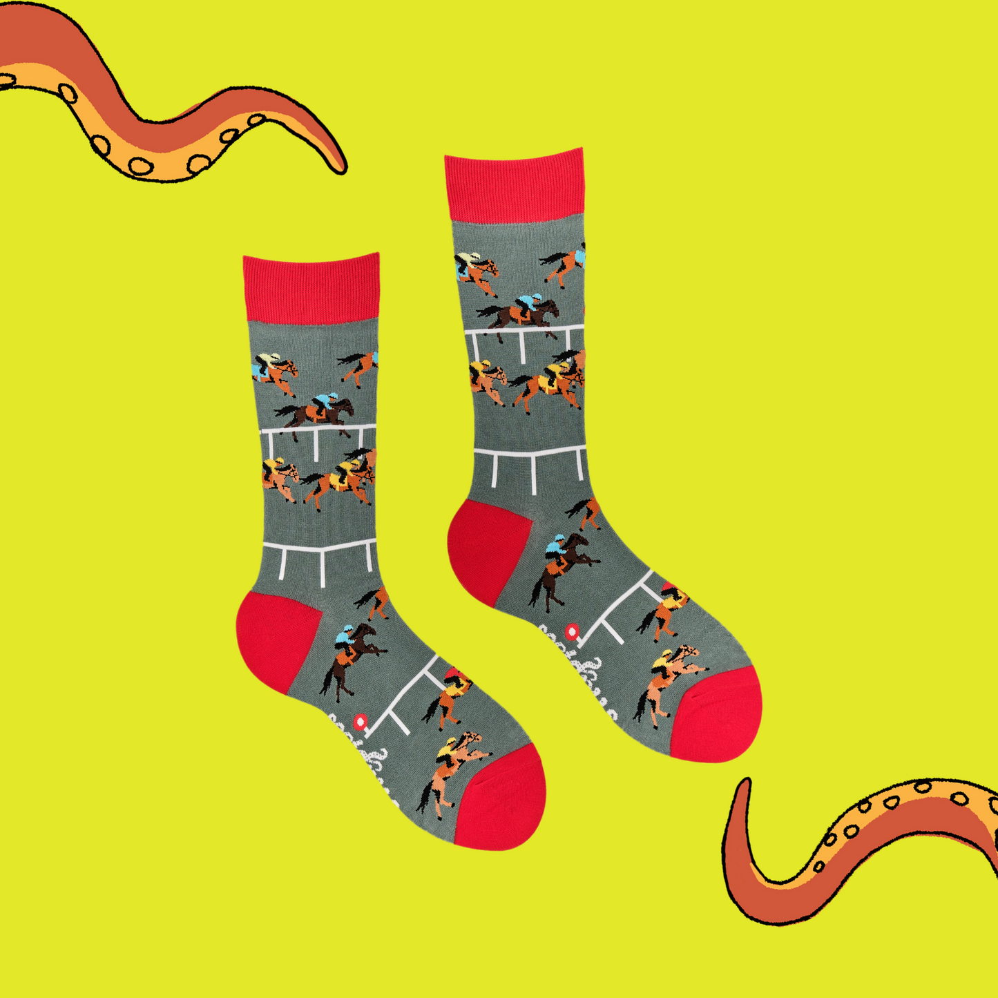 A pair of socks depicting horse racing. Grey legs, red cuff and, heel and toe.