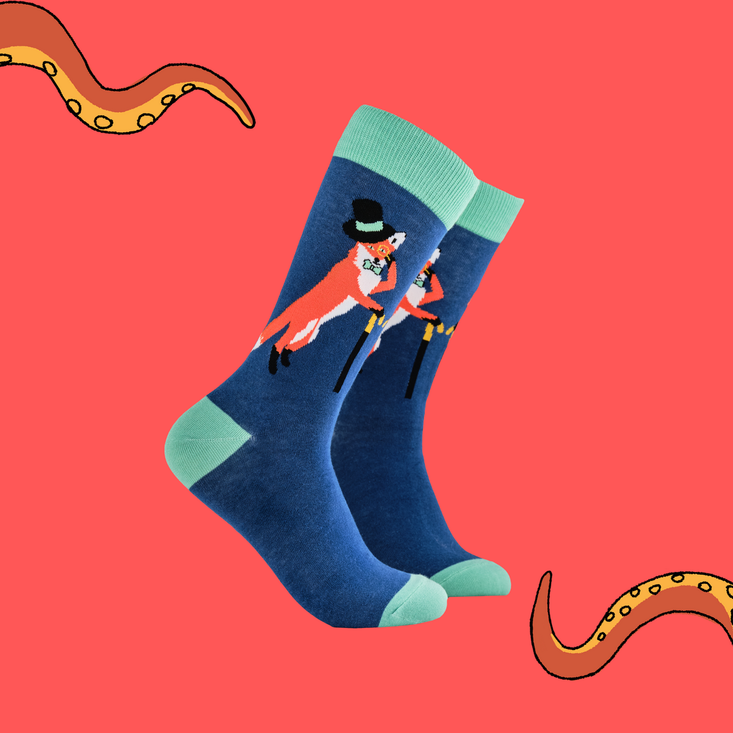 A pair of socks depicting a fox in a top hat and monocle. Blue legs, green cuff, heel and toe.
