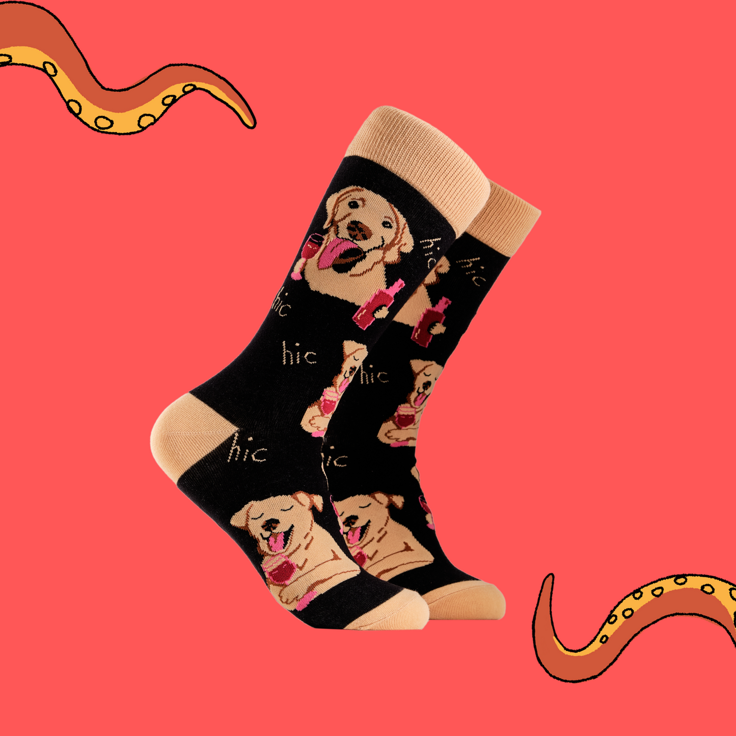 A pair of socks depicting labs drinking wine. Black legs, light brown cuff, heel and toe.