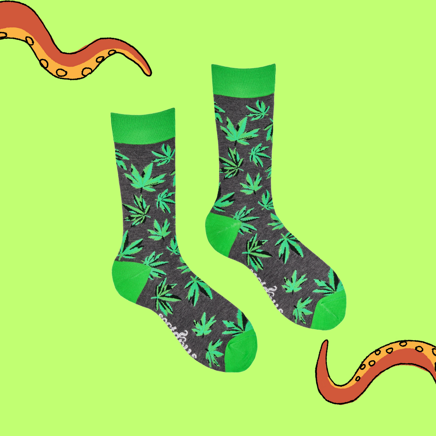 A pair of socks depicting cannabis leaves. Grey legs, bright cuff, heel and toe.