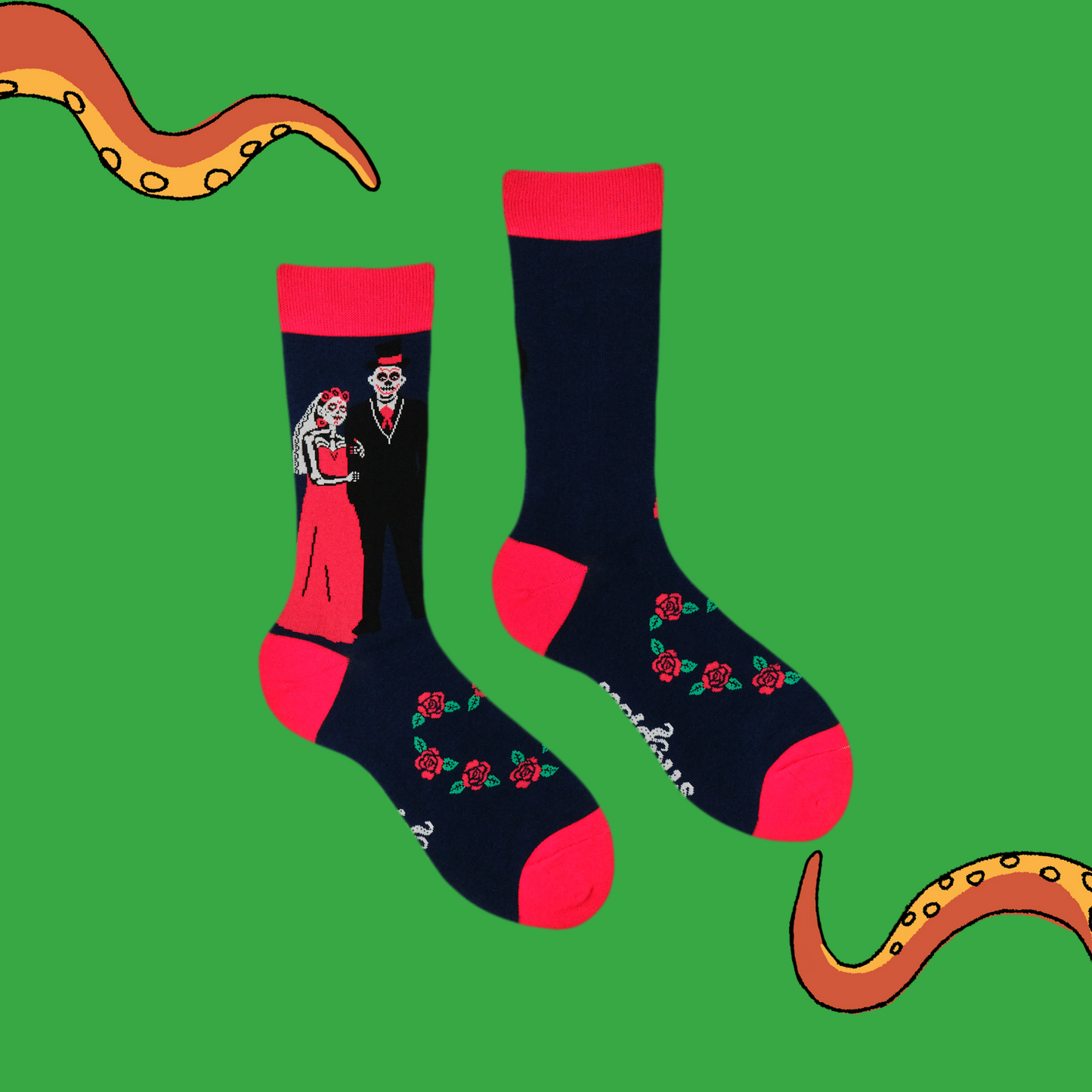A pair of socks with a day of the dead motif. Dark blue legs, red heel, toe and cuff.
