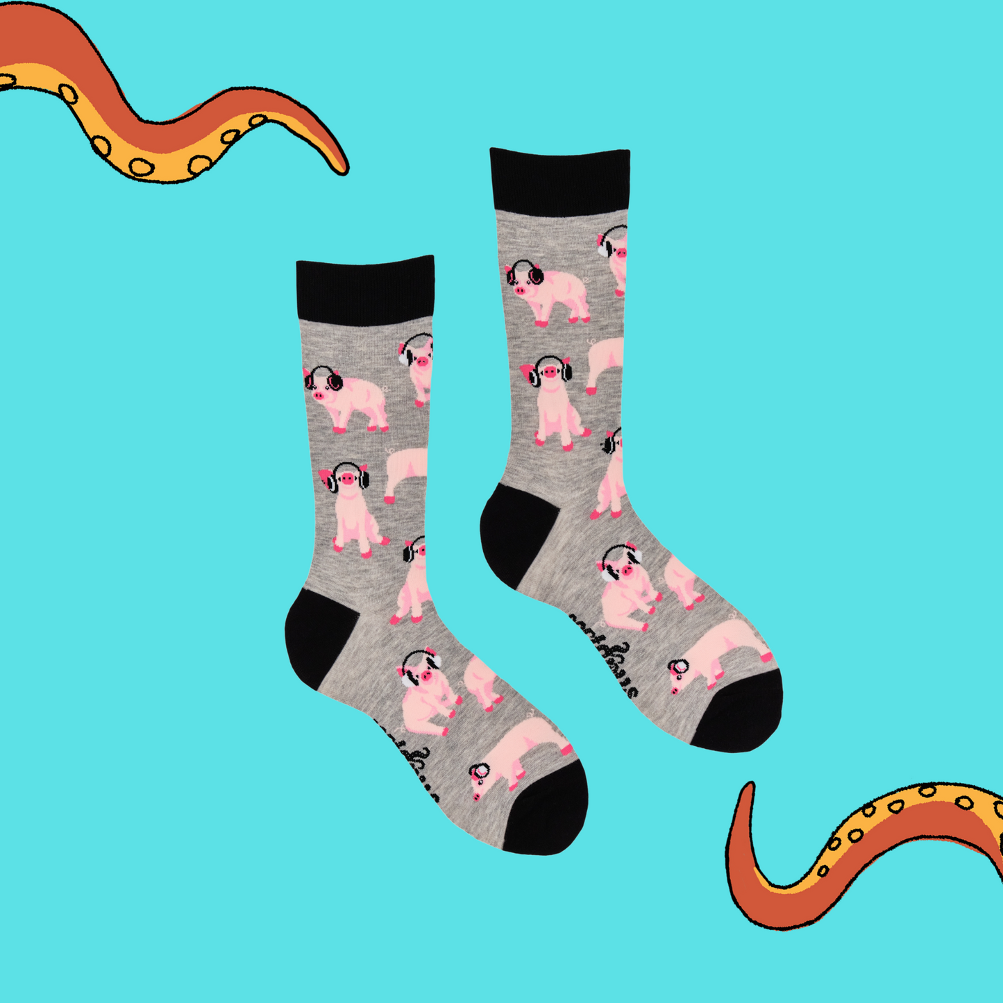 A pair of socks depicting Pigs being wearing headphones. Light grey legs, black cuff, heel and toe. Blue background with Soctopus tentacles.