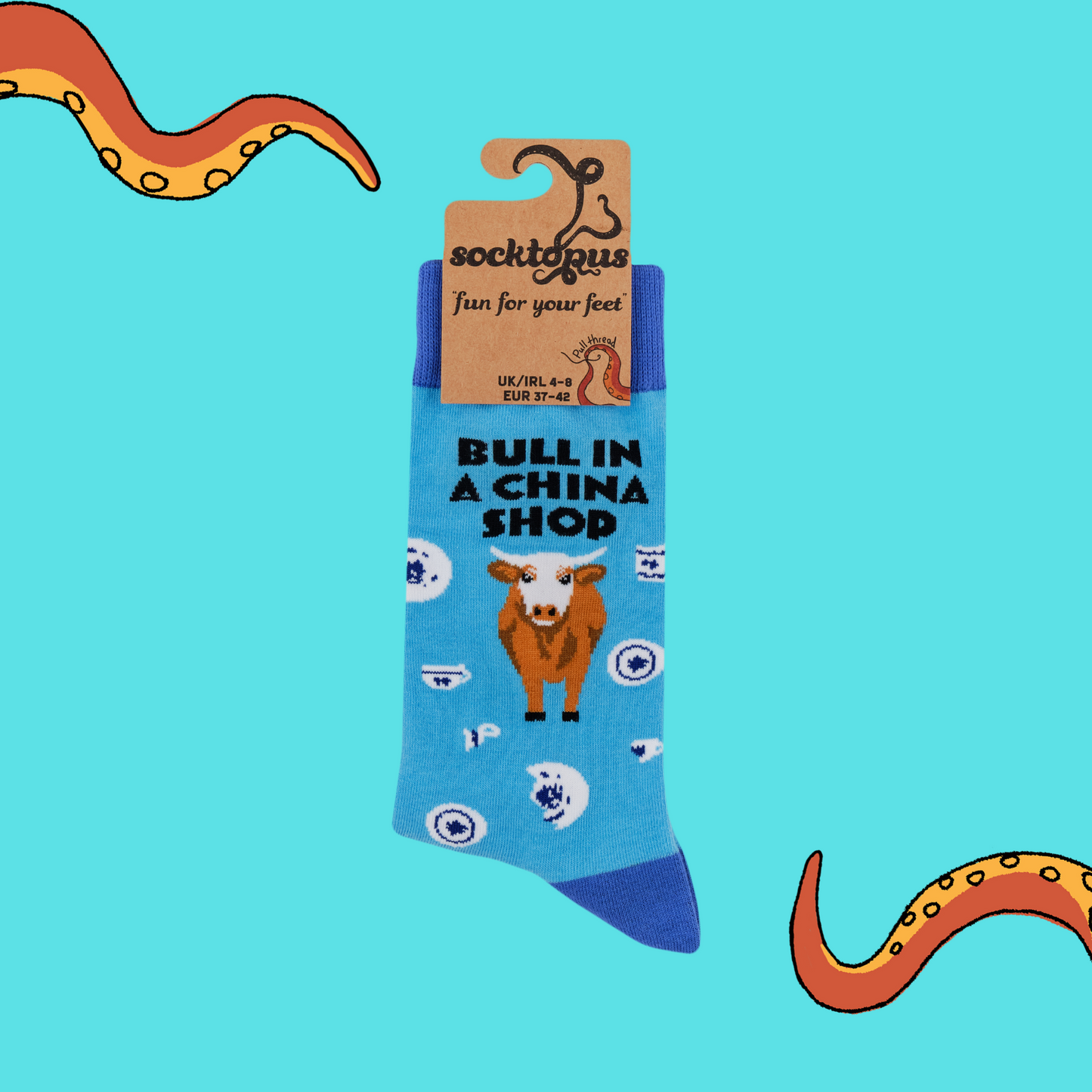 A pair of socks featuring a bull in a china shop. Light blue legs, dark blue heel, toe and cuff.