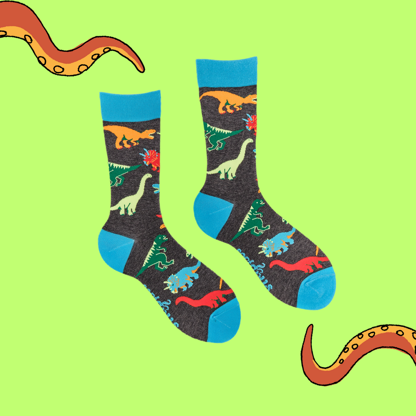 A pair of socks depicting dinosaurs. Grey legs, light blue cuff, heel and toe.