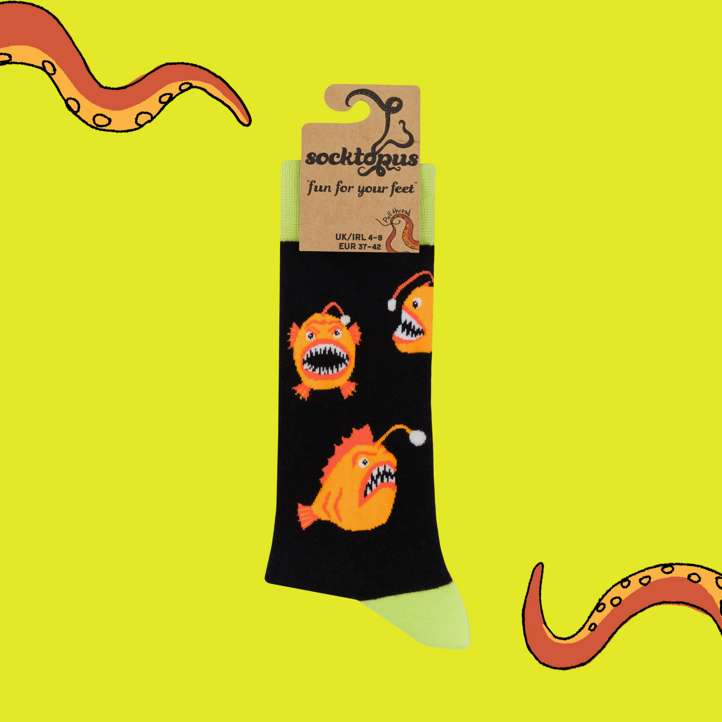 A pair of socks with an angler fish motif. Black legs, yellow heel toe and cuff