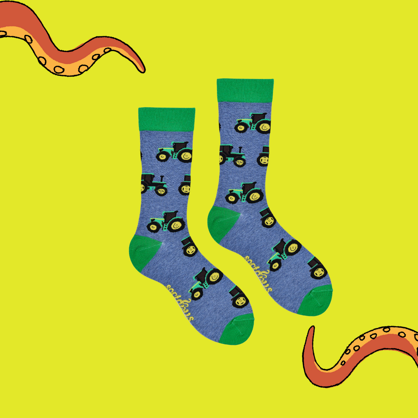A pair of socks depicting green tractors. Blue legs, green cuff, heel and toe.