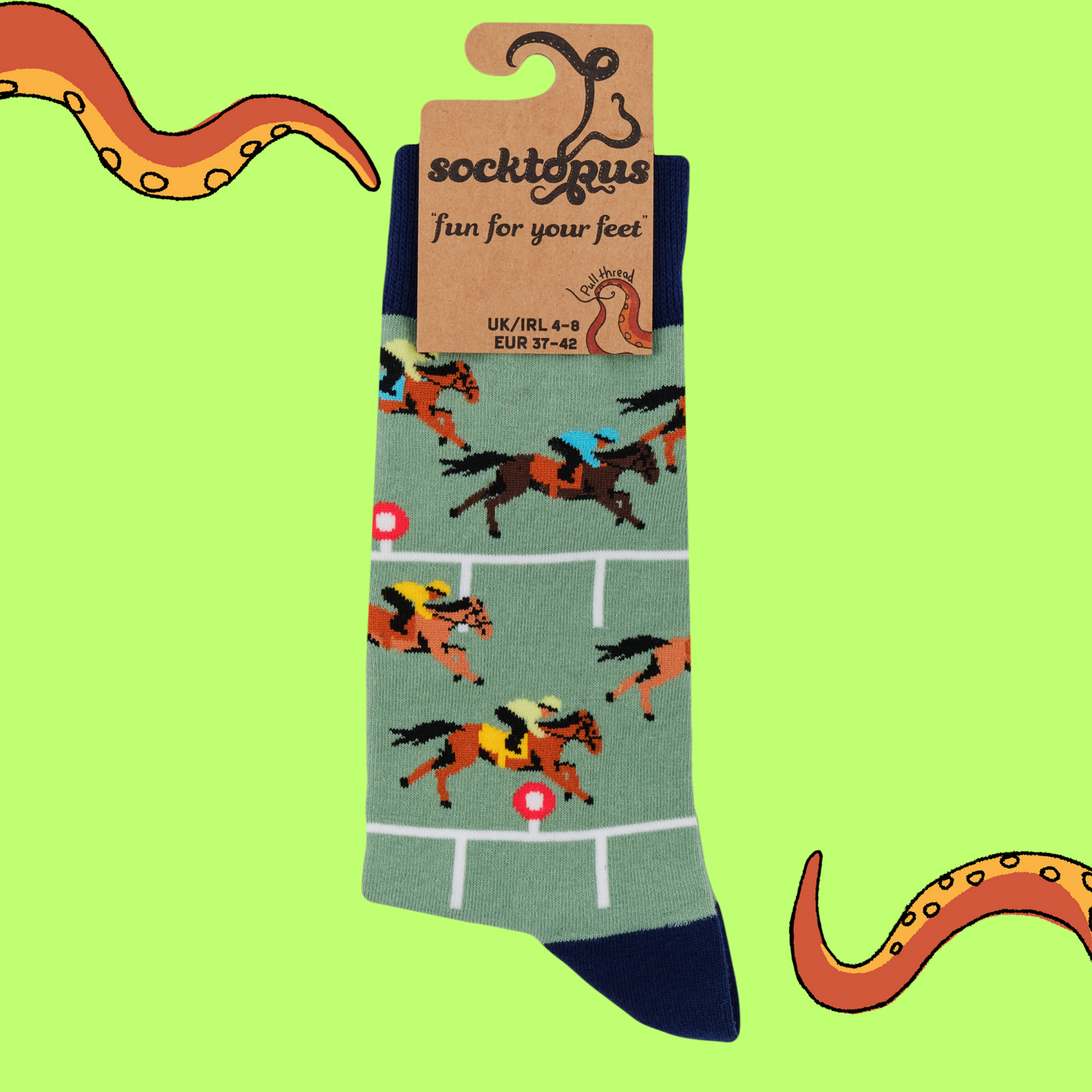 A pair of socks depicting horse racing. Green legs, black cuff, heel and toe.