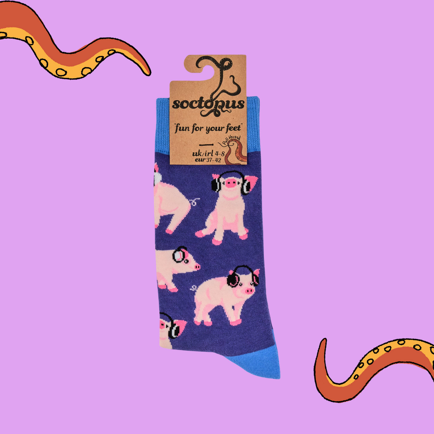 A pair of socks depicting Pigs being wearing headphones. Blue legs, Blue cuff, heel and toe.
