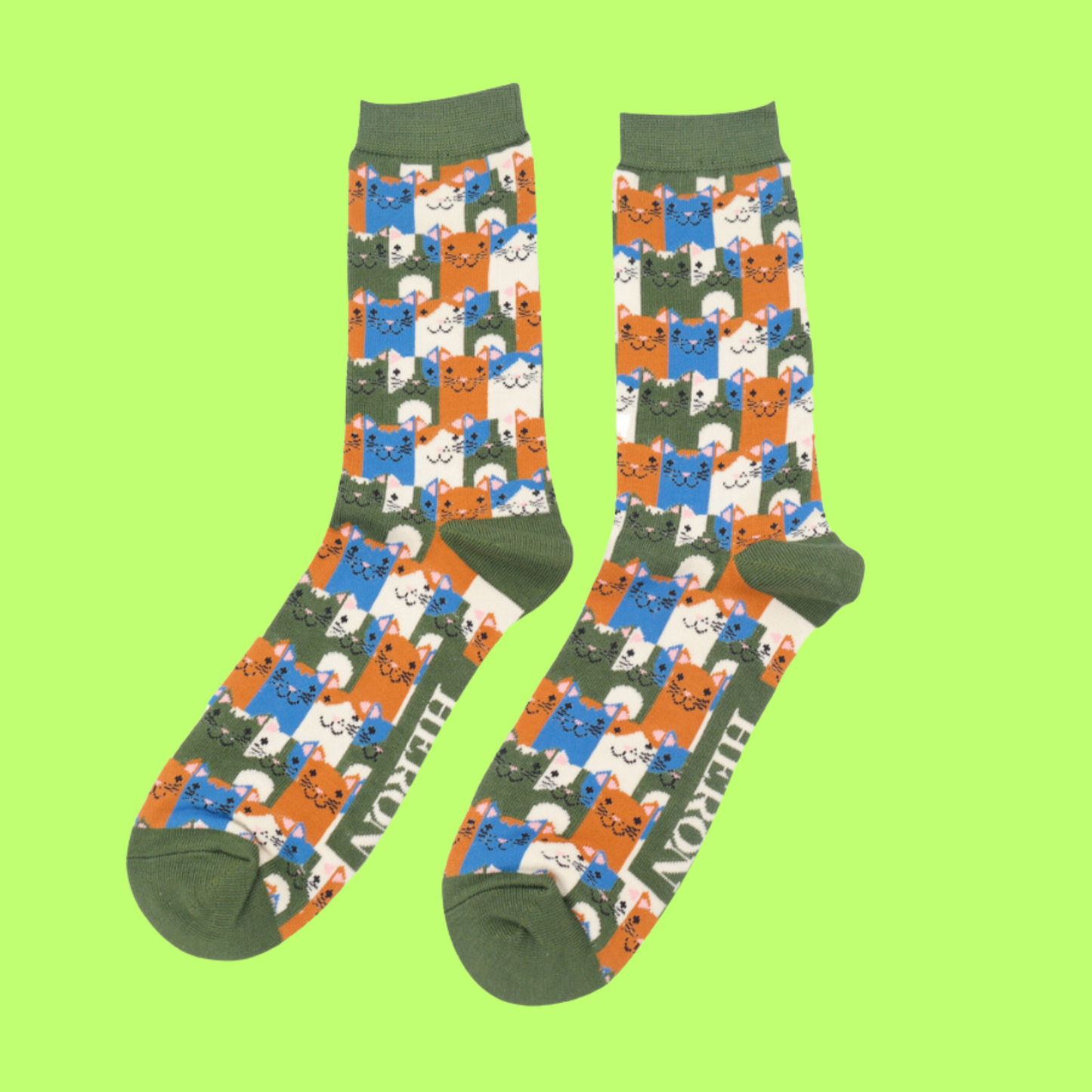 A pair of socks with a multicoloured happy anime cat pattern. Green heel, toe and cuff.