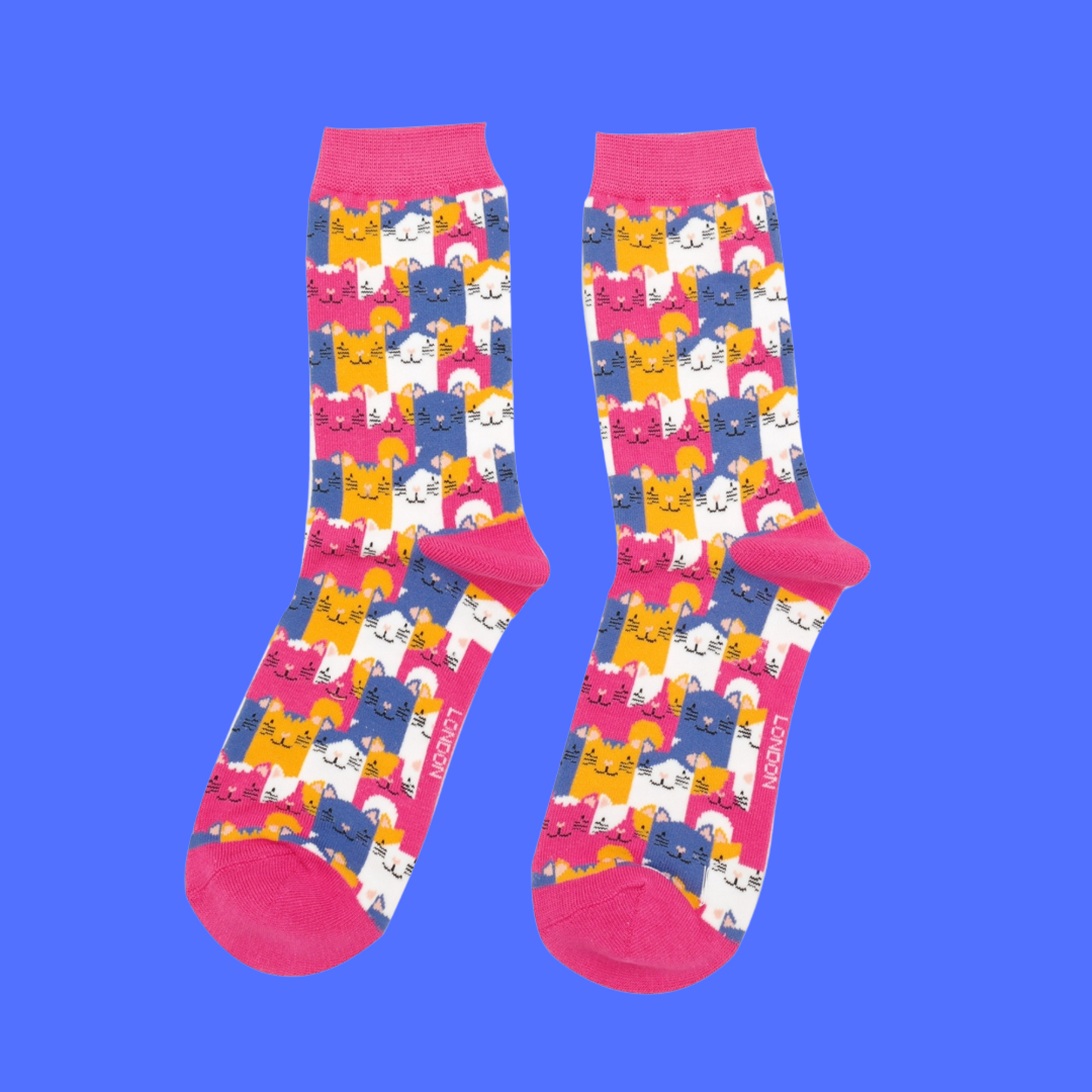 A pair of socks with a multicoloured happy anime cat pattern. Bright pink heel, toe and cuff.