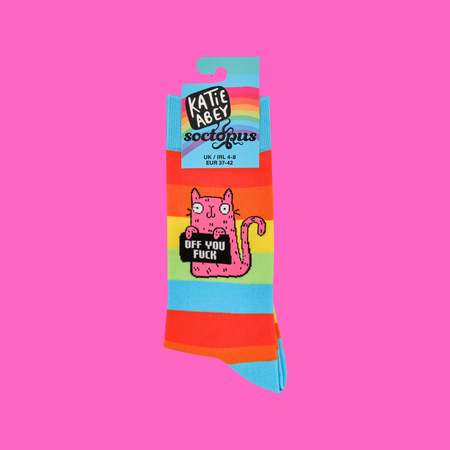 A pair of socks featuring a cute cat holding a sweary sign. Rainbow legs.