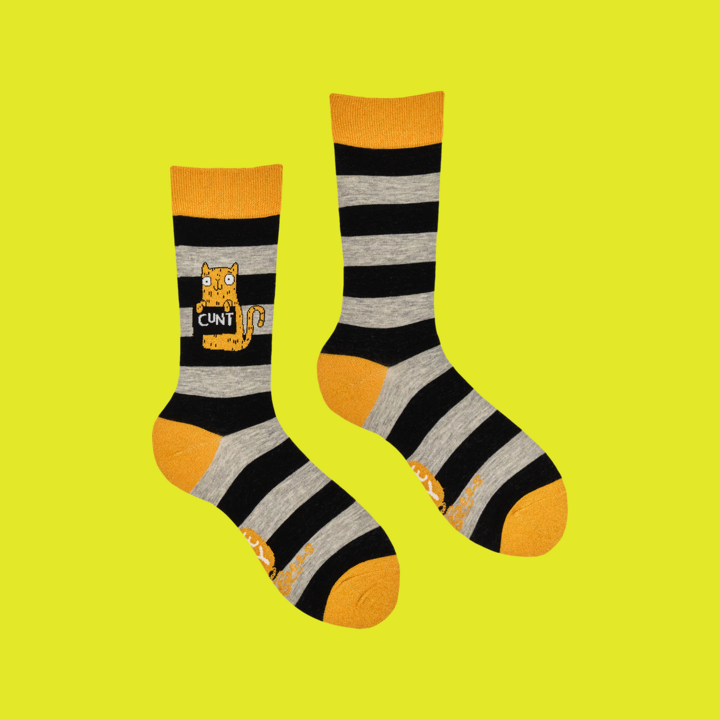 A pair of socks featuring a cute cat holding a sweary sign. Black and grey striped legs. Yellow heel, cuff and toe.