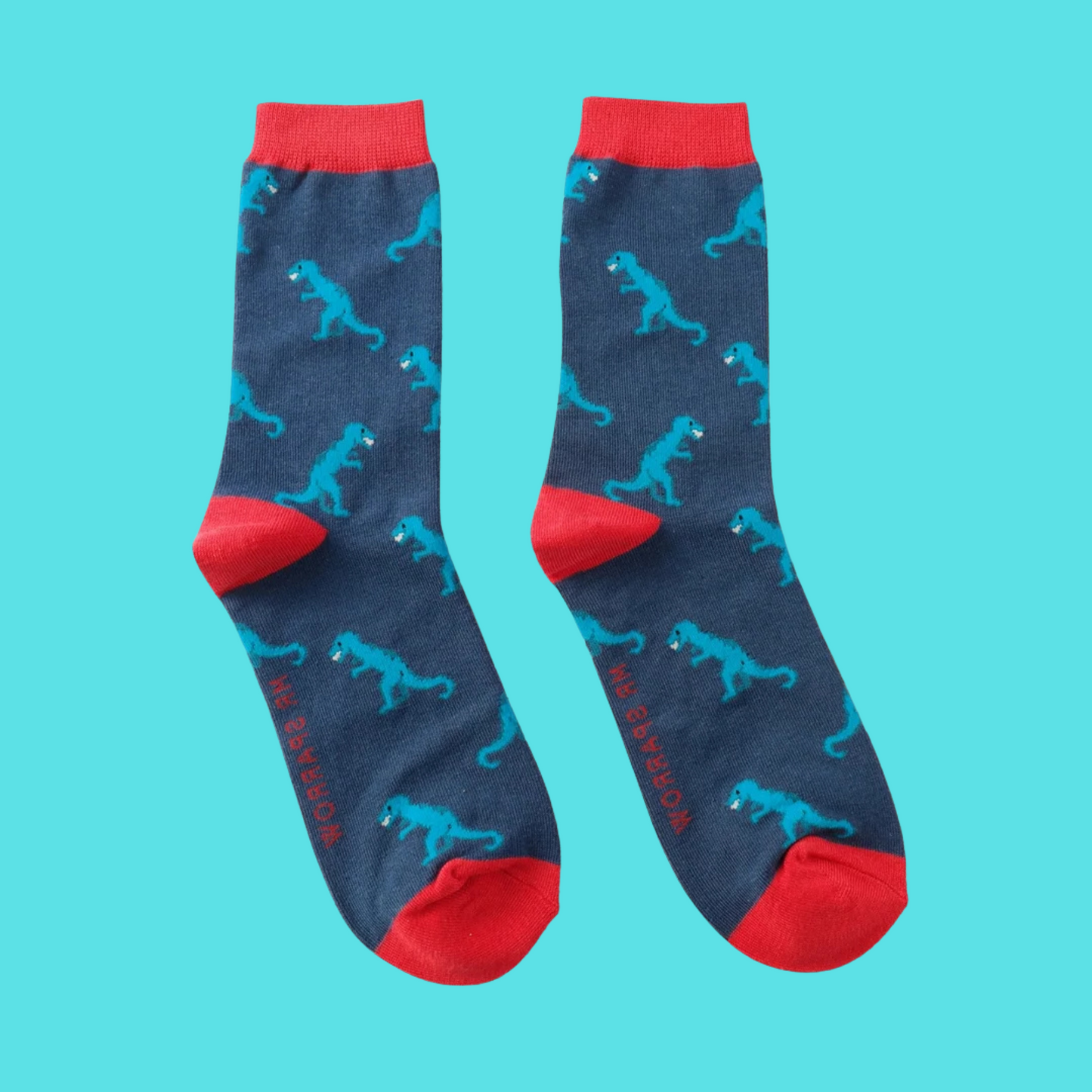 Dino Bamboo Socks - Miss Sparrow. A pair of socks with a dinosaur motif. Blue legs, red heel, toe and cuff.
