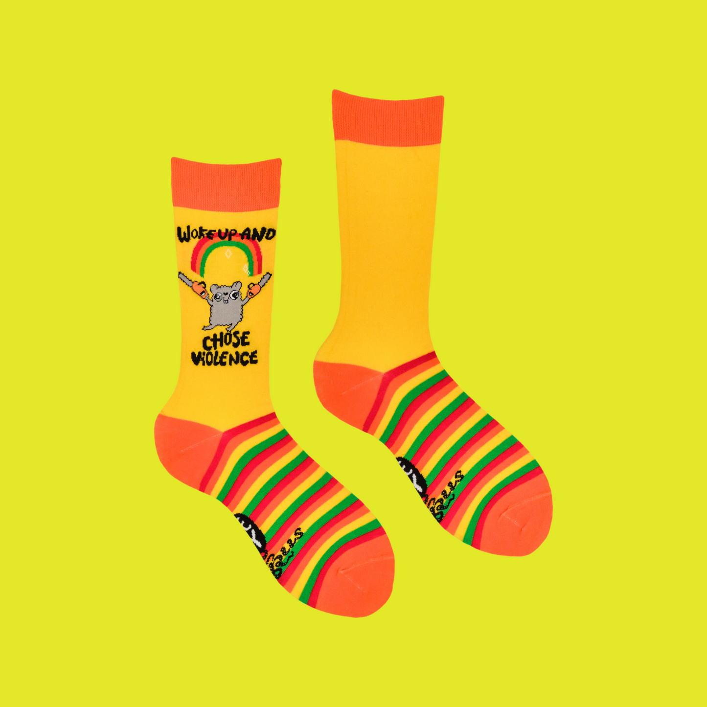 A pair of socks depicting a mouse holding chainsaws with the slogan 'woke up and chose violence'. Yellow striped legs, orange toe cuff and heel.