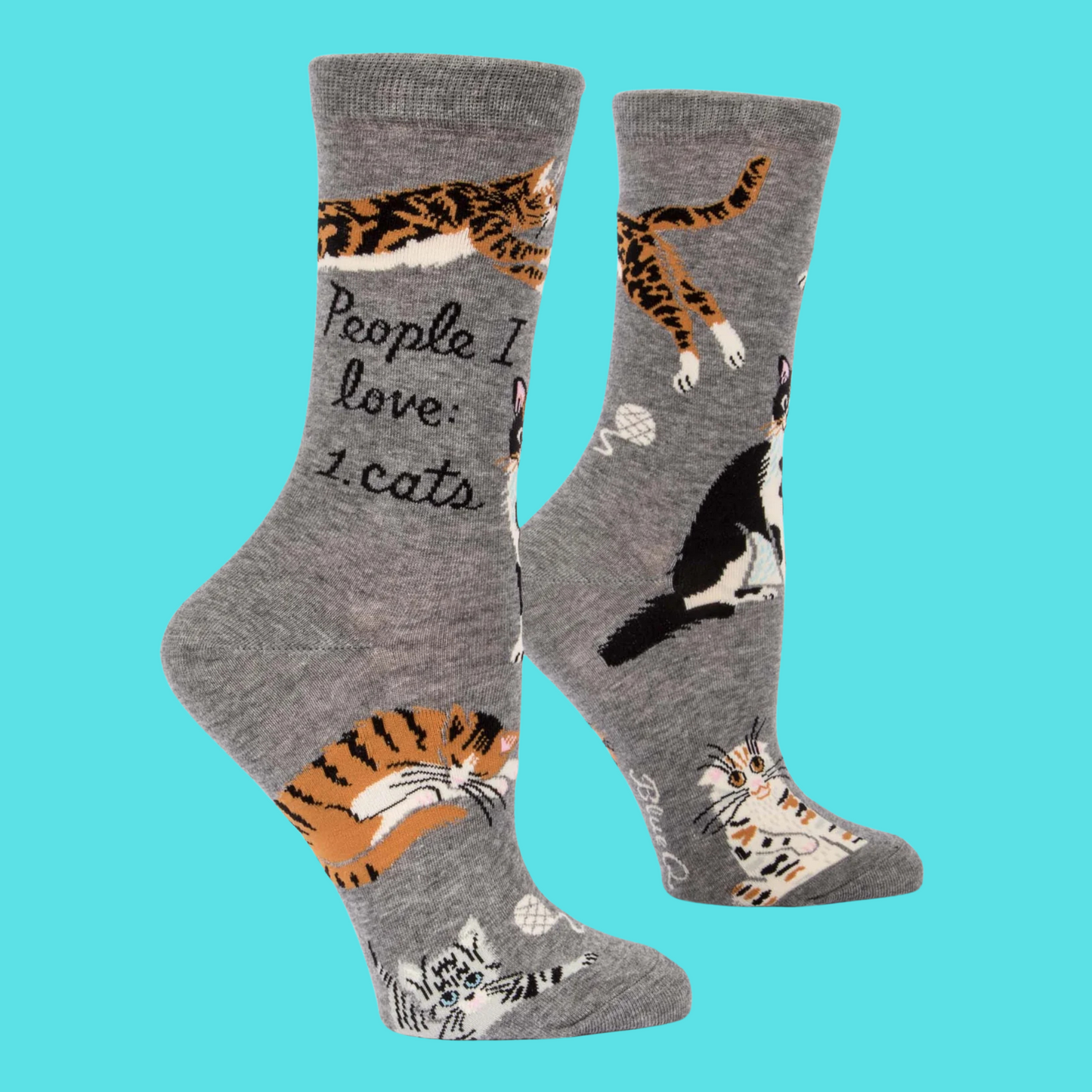 A pair of socks featuring playful cats. Grey legs, heel, toe and cuff.