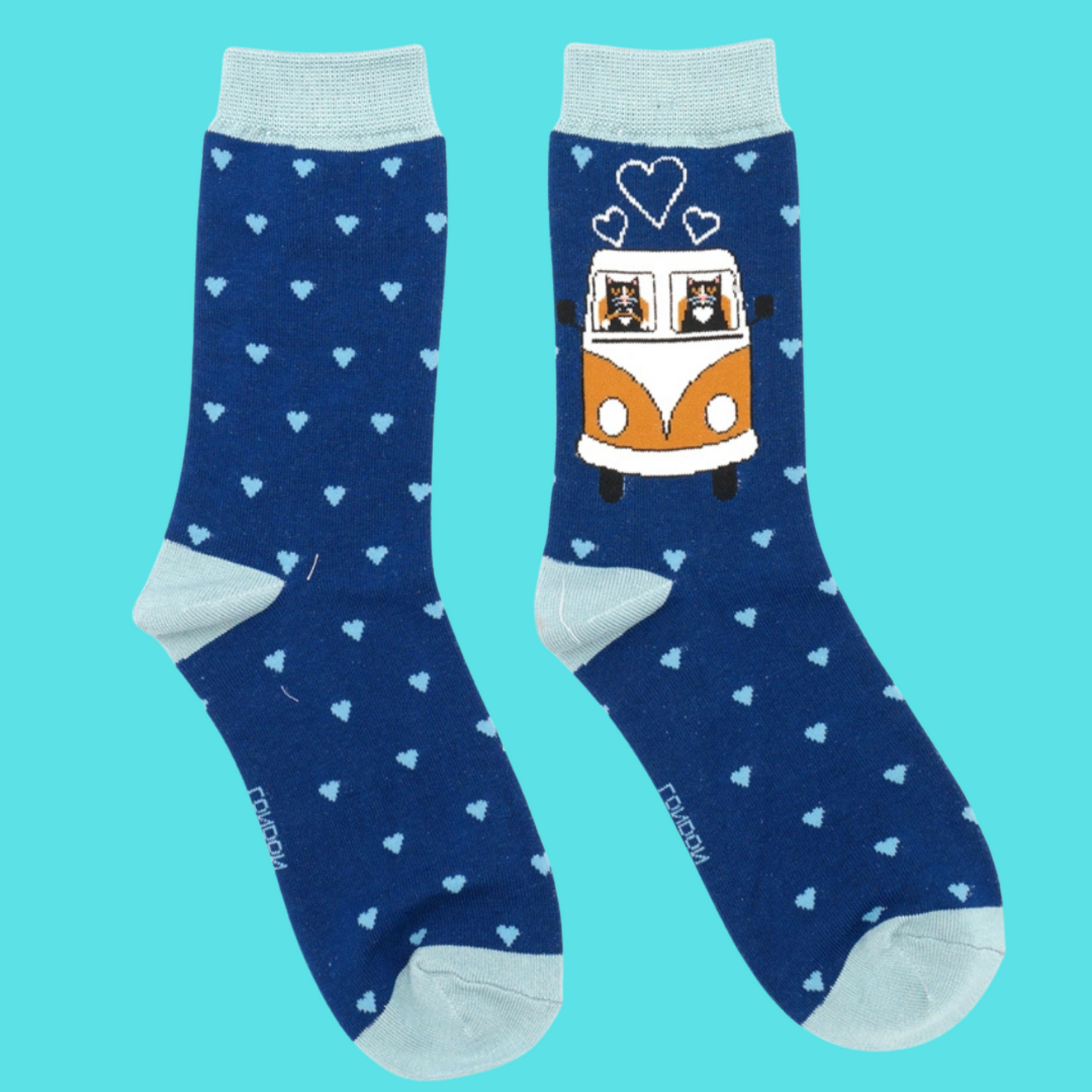 A pair of socks featuring cats in a camper van. Dark blue legs, light blue heel, toe and cuff.