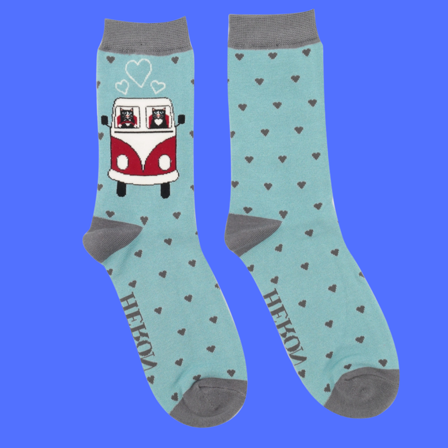 A pair of socks featuring cats in a camper van. Light legs, greey heel, toe and cuff.