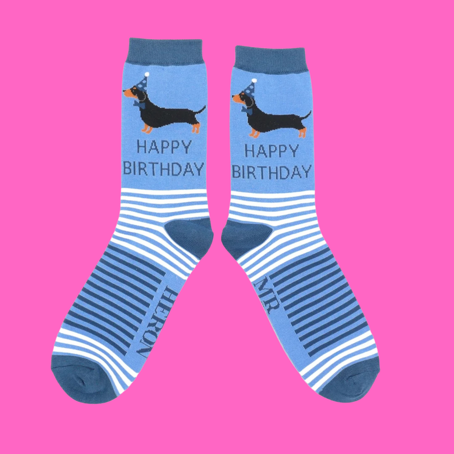 A pair of socks featuring sausage dogs all dressed up for a party. Blue legs, Dark blue heel, toe and cuff.