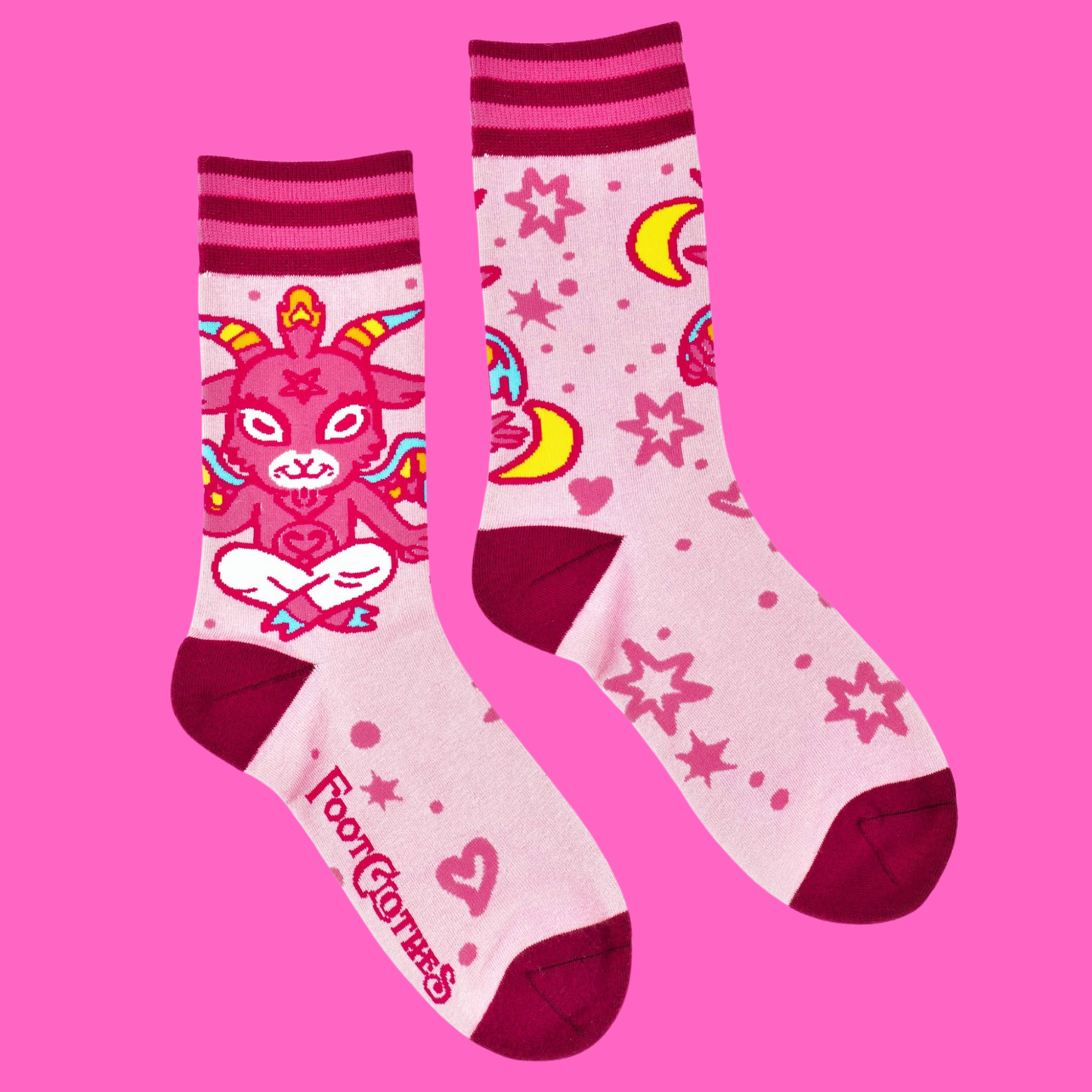 A pair of socks featuring a cute little devil. Pink legs, bright pink heel, toe and cuff.