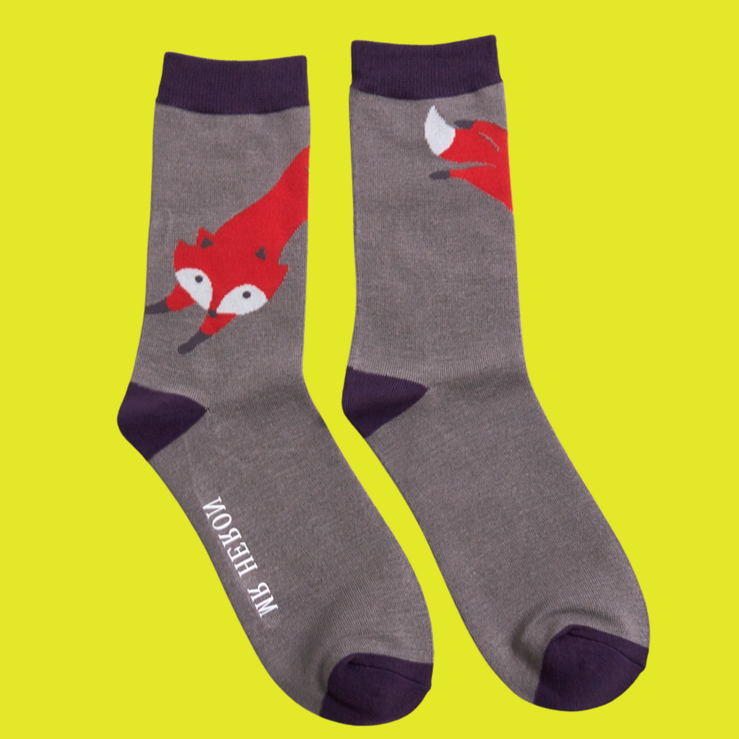 Leaping Fox Bamboo Socks - Miss Sparrow. A pair of socks with a stylised fox motif. Grey legs, purple heel, toe and cuff.