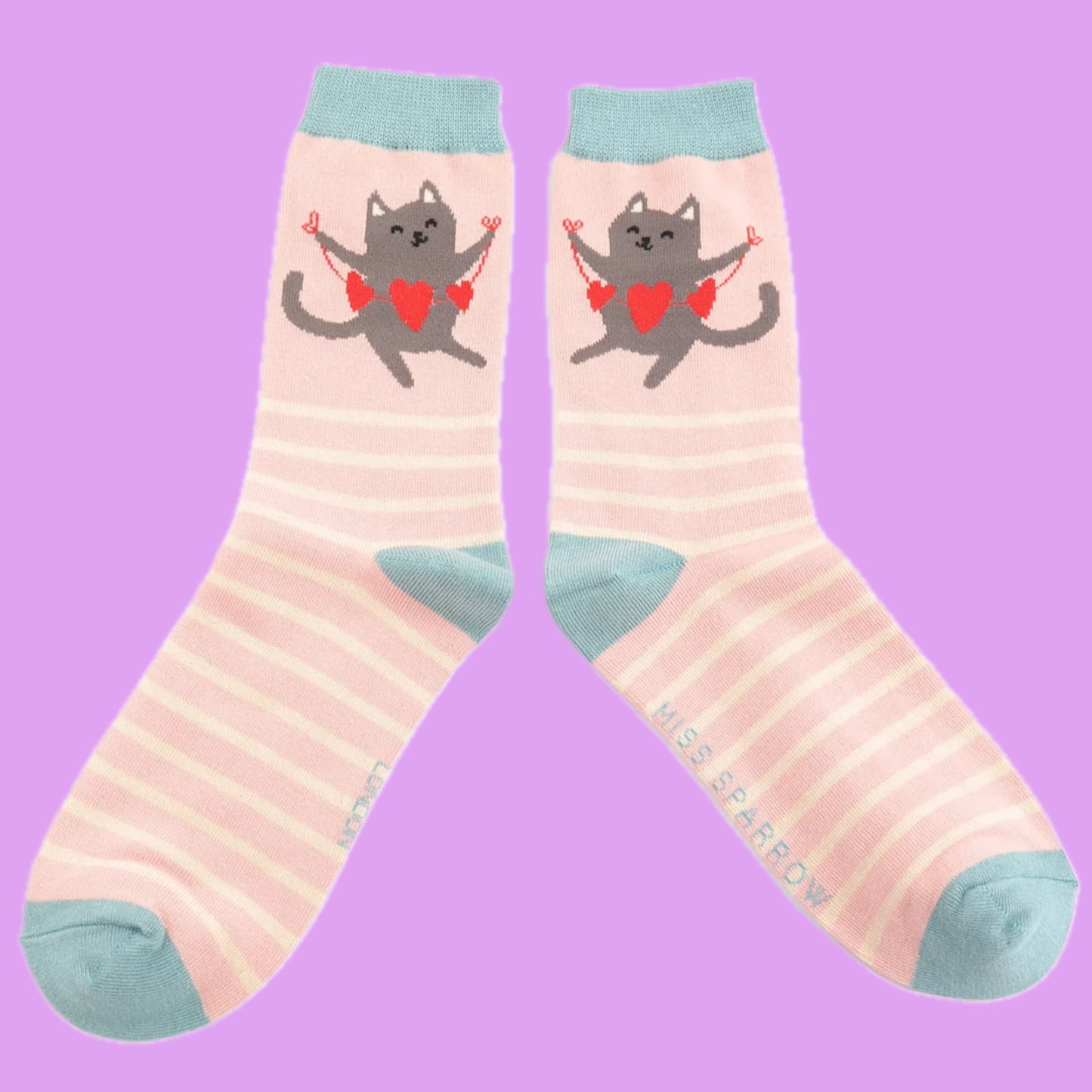 A pair of socks featuring a happy cat. Pink striped legs. Blue heel toe and cuff.