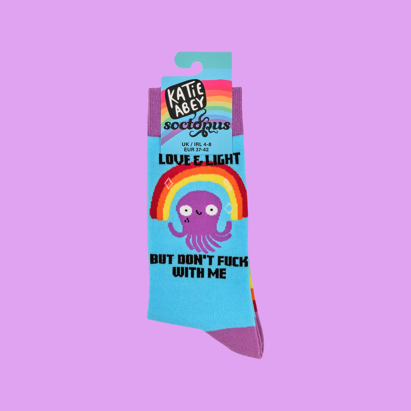 A pair of socks depicting a happy octopus and a sweary slogan. Blue legs. Striped foot and pink heel toe and cuff.