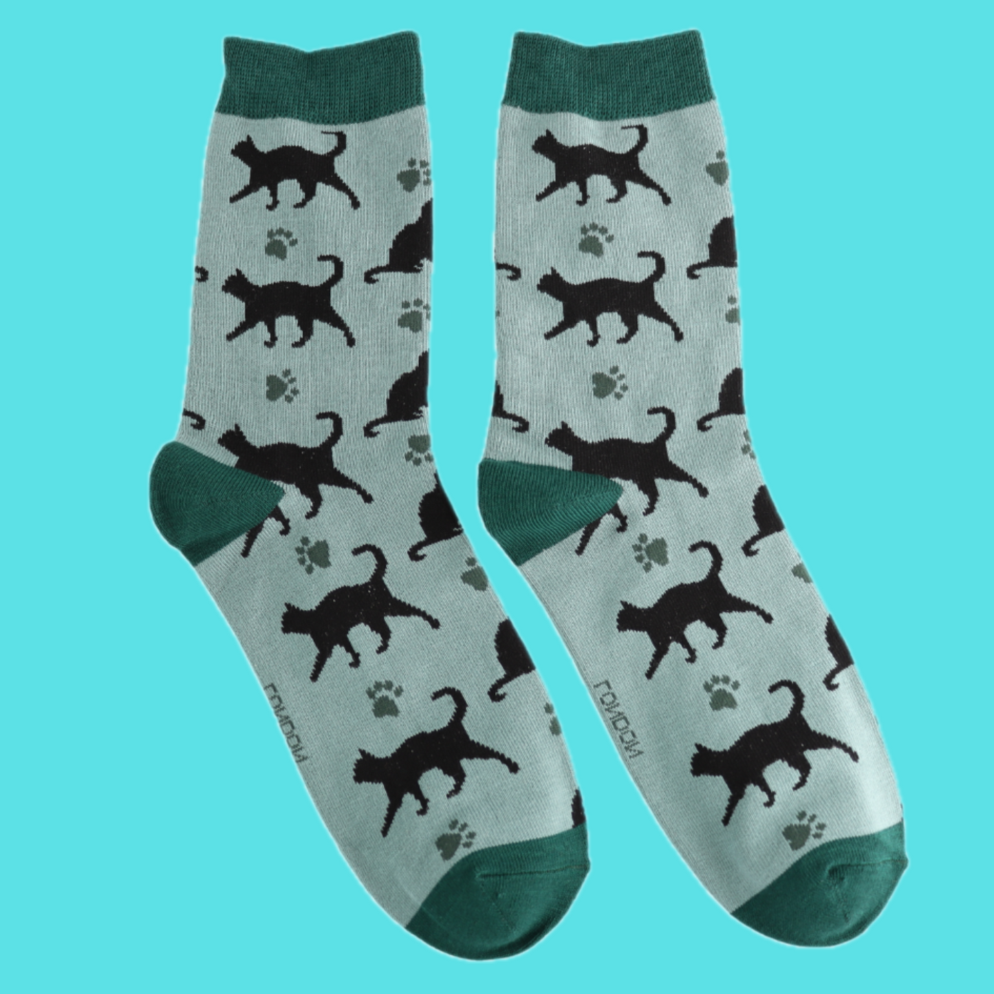 A pair of socks featuring cats and cat prints. Light green legs, dark green heel, toe and cuff.