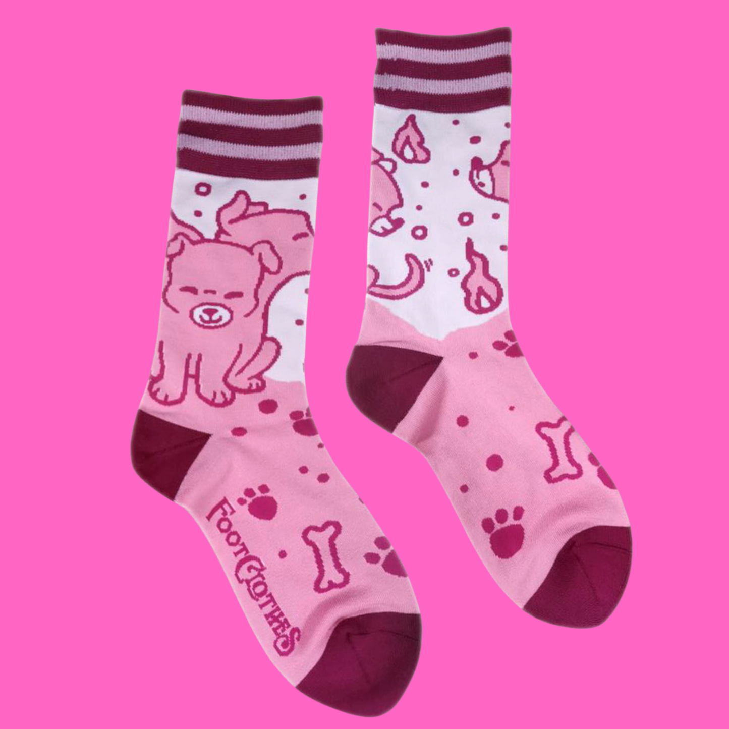 A pair of socks featuring a cute 3 headed dog. Pink legs, dark pink heel, toe and cuff.