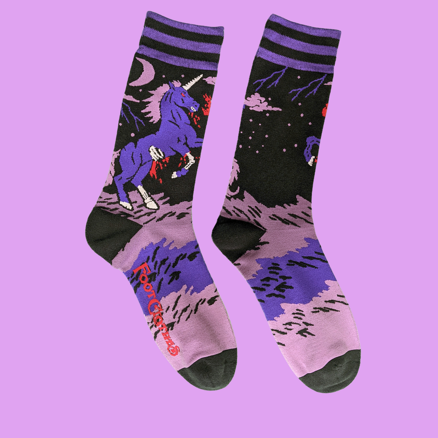 A pair of socks with a dark and twisted unicron motif. Pink and purple legs, black heel, toe and cuff.