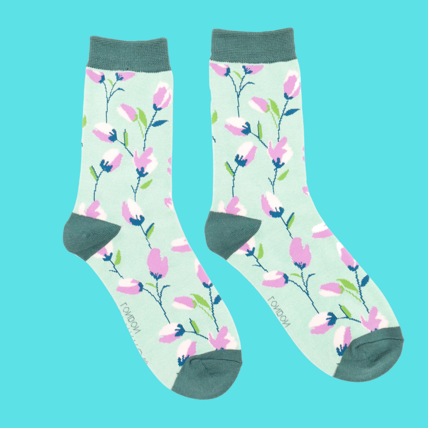 A pair of socks with a fun floral pattern. Green legs, green cuff, heel and toe.