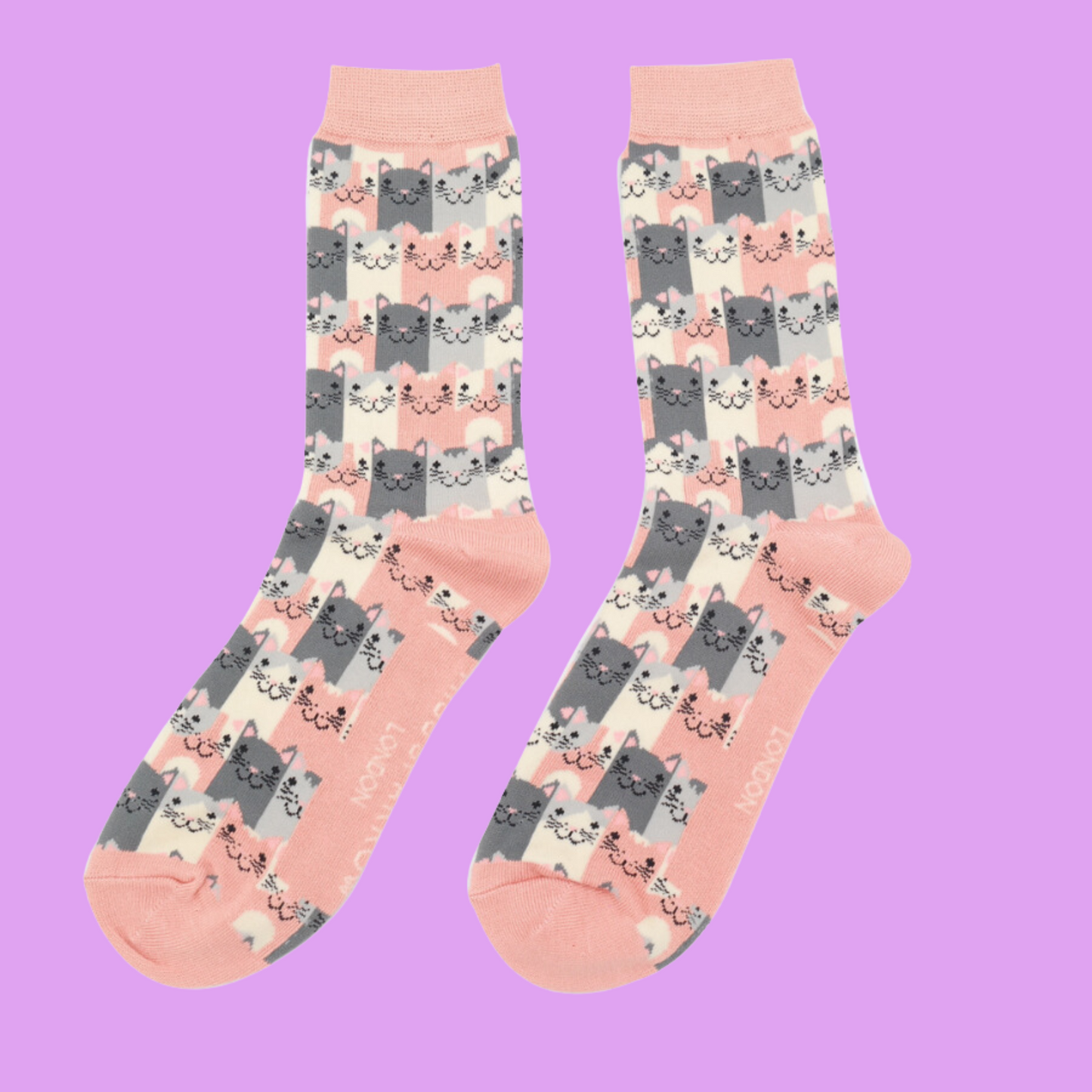 A pair of socks with a multicoloured happy anime cat pattern. Peach heel, toe and cuff.