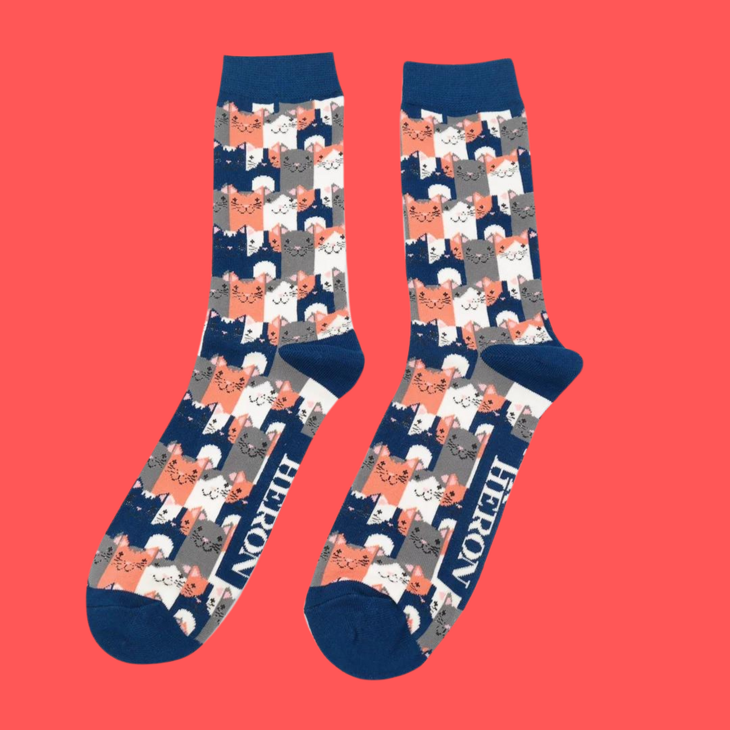 A pair of socks with a multicoloured happy anime cat pattern. Blue heel, toe and cuff.