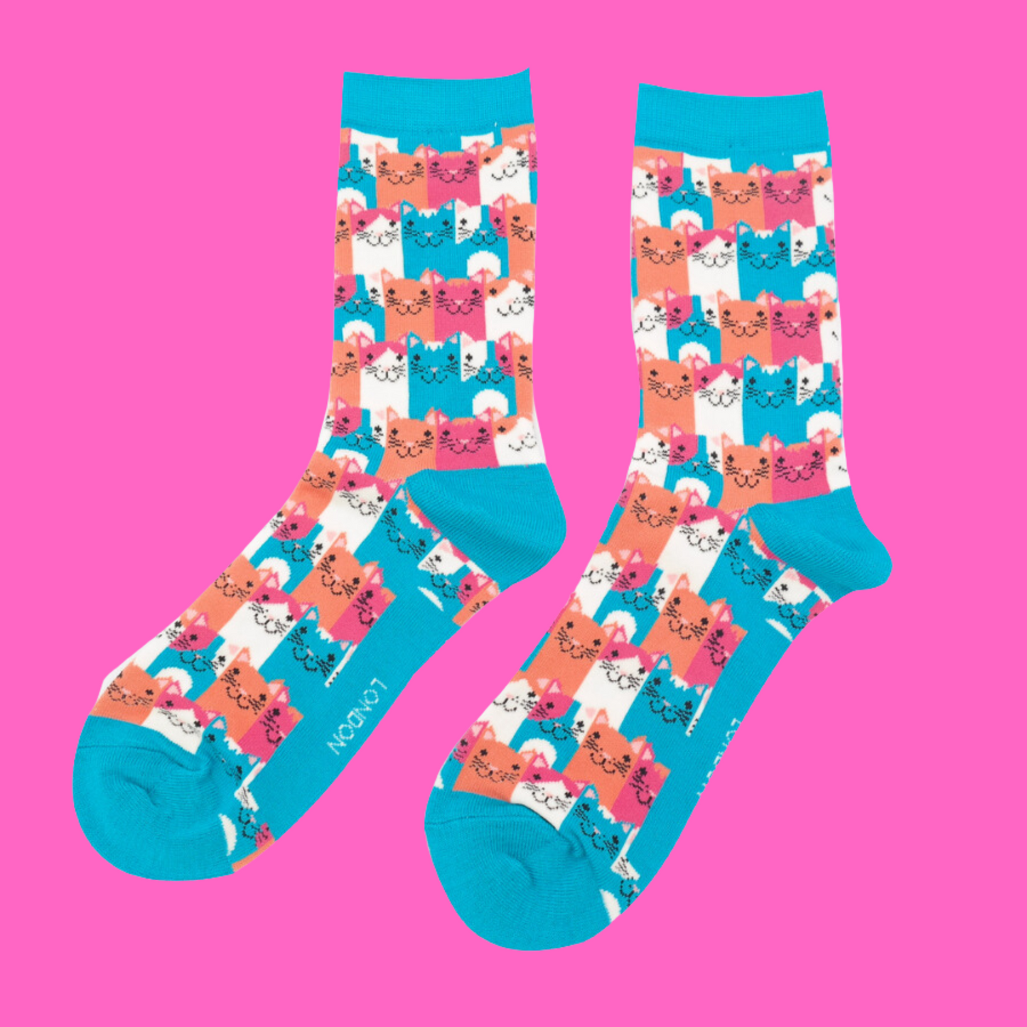 A pair of socks with a multicoloured happy anime cat pattern. Bright blue heel, toe and cuff.