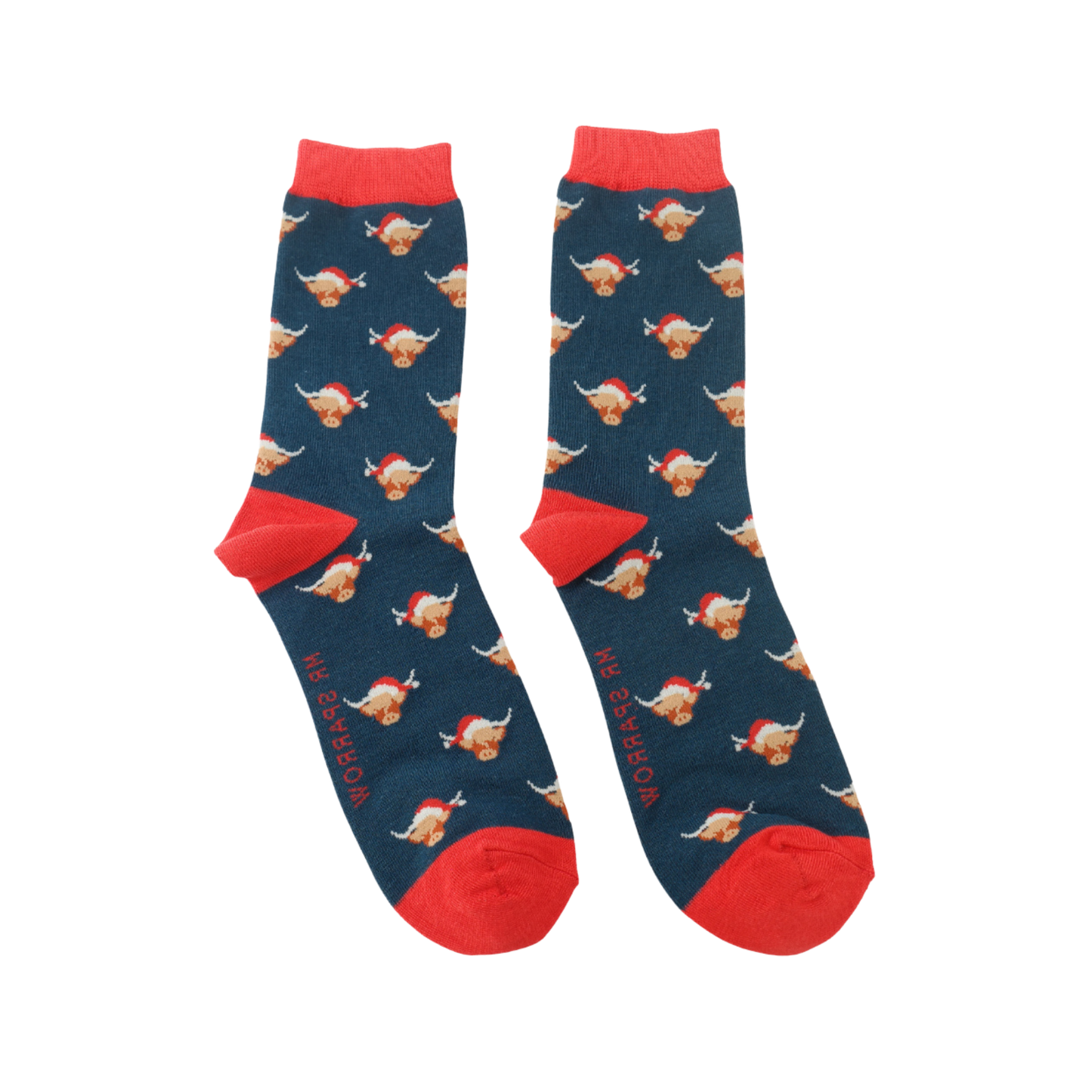 A pair of socks with a festive highland cow pattern. Dark blue legs, red heel, toe and cuff.