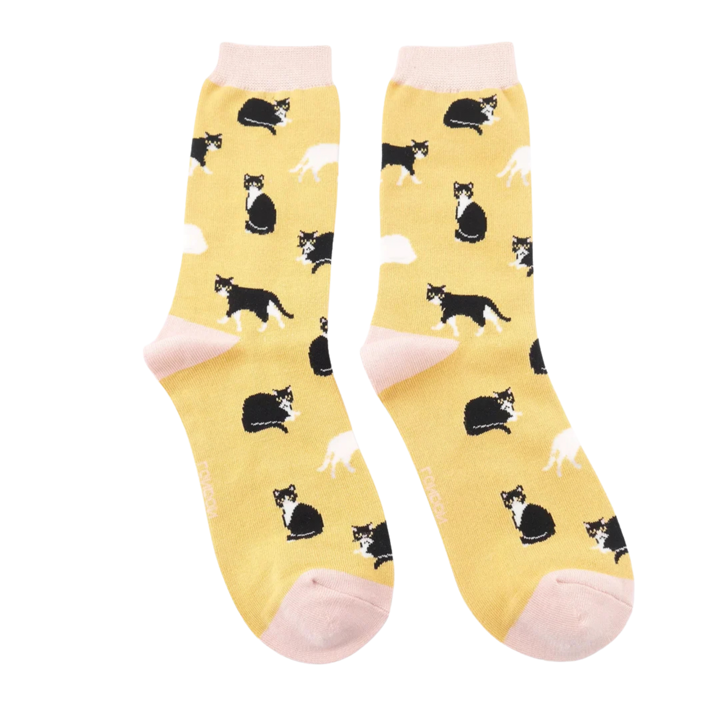 A pair of socks featuring black and white cats. Yellow legs, cream heel, toe and cuff.