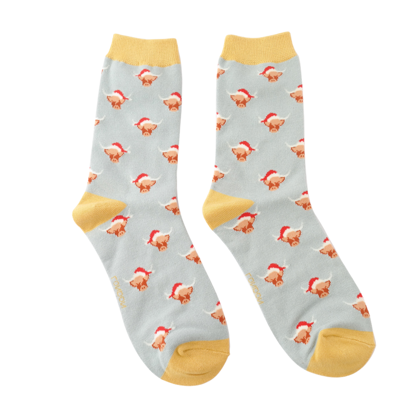 A pair of socks with a festive highland cow pattern. Grey legs, yellow heel, toe and cuff.