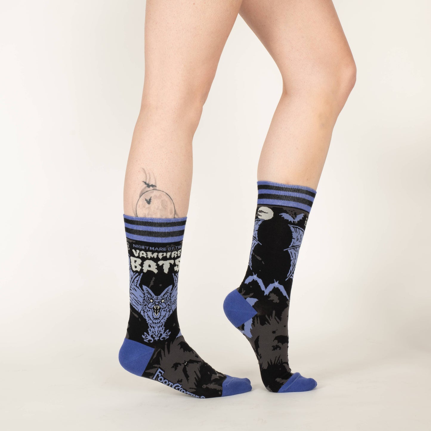 A pair of socks depicting a scary looking vampire bat. Blue toes, cuff and heel.