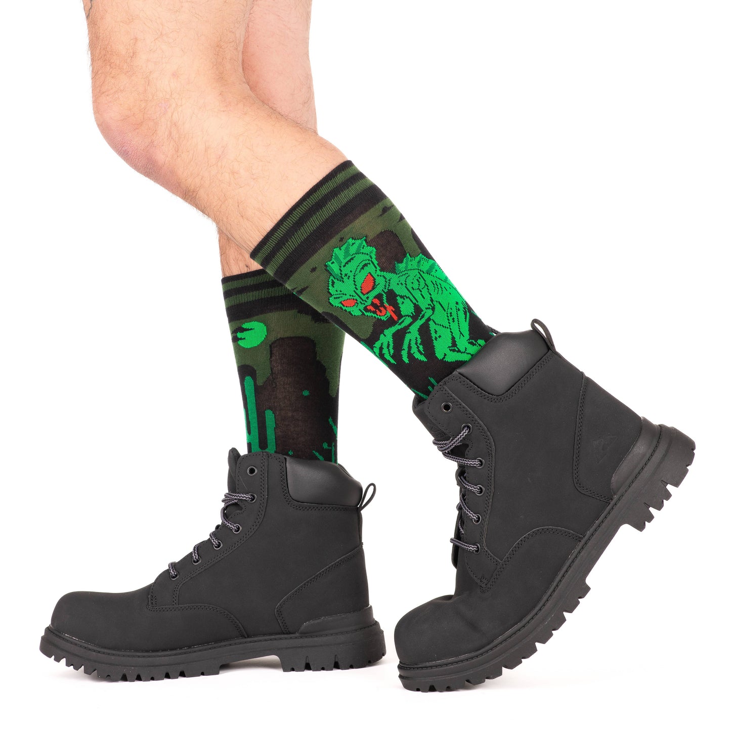 A model wearing a pair of socks featuring El Chupacabra. Green legs, heel, toe and cuff.