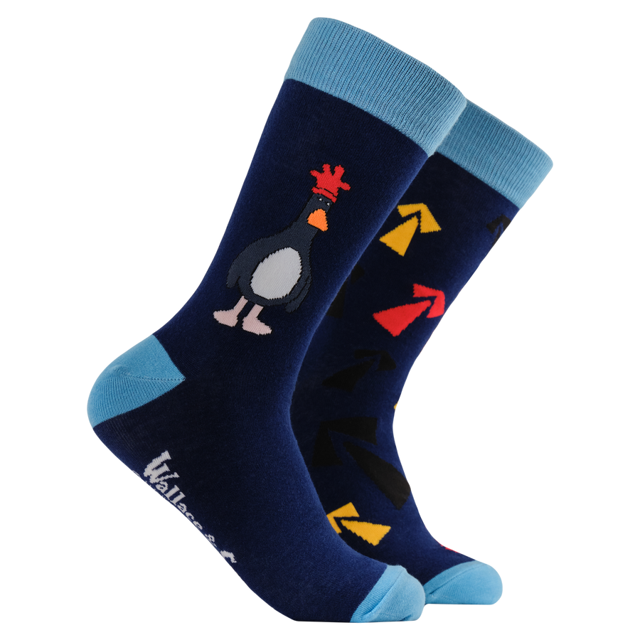 Navy blue socks with Wallace & Gromit themes on a white background.