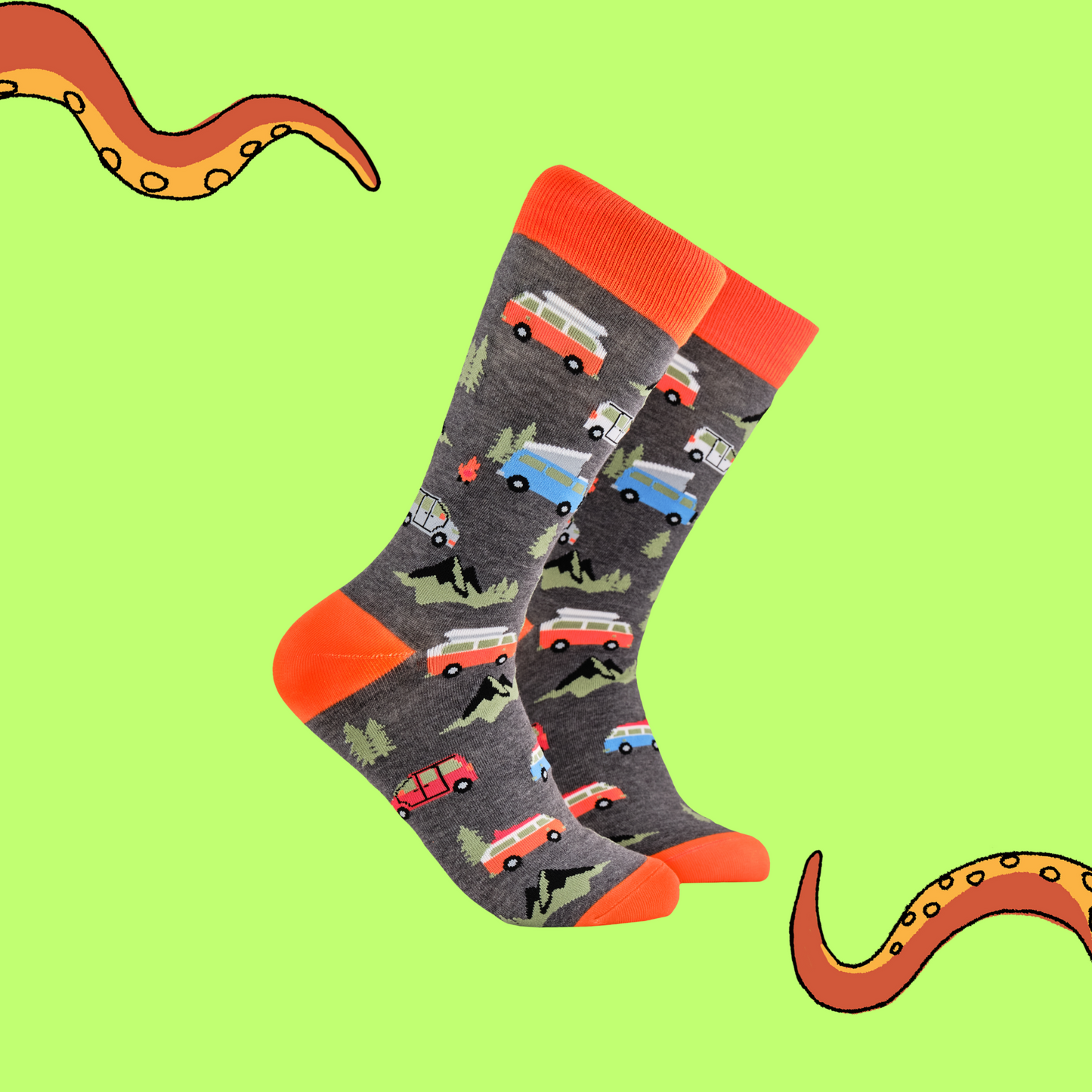 A pair of socks depicting red and blue vintage camper van. Grey legs, orange cuff, heel and toe.