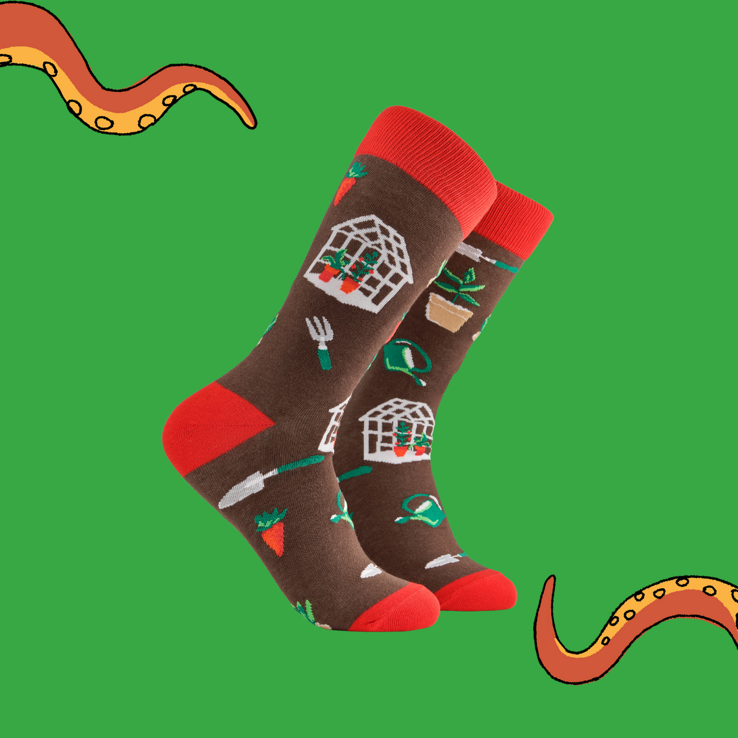 A pair of socks depicting garden tools and greenhouses. Brown legs, red cuff, heel and toe.
